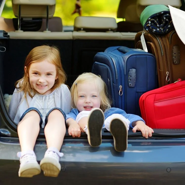 Photo from Family Living article of two little girls going on vacation with parents