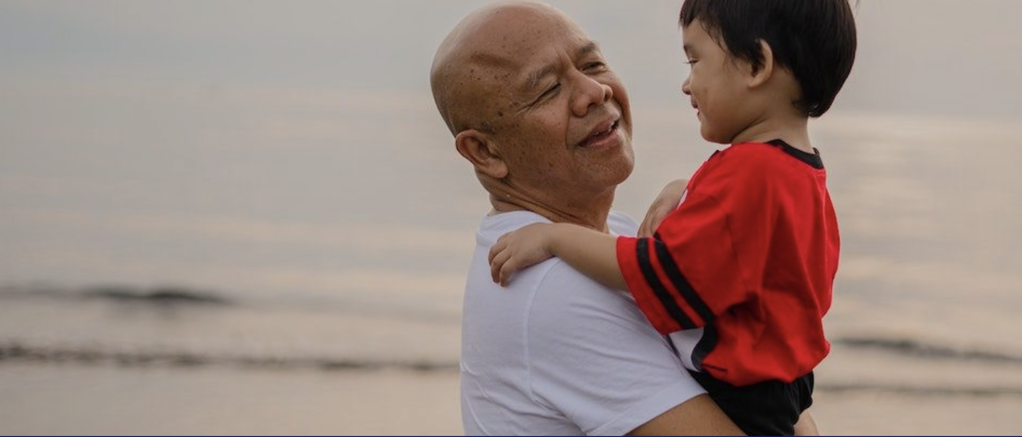 Photo of grandfather holding small child