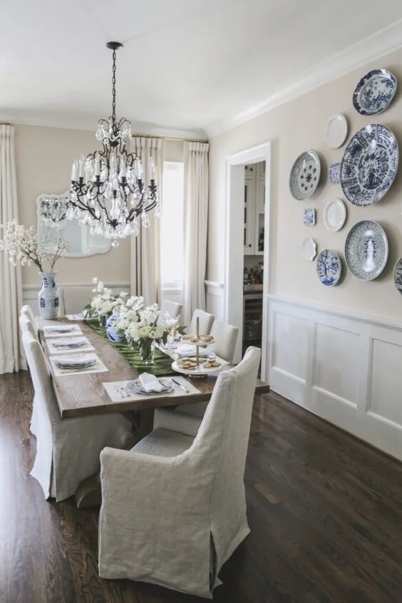 dining room with blue plates hung on wall