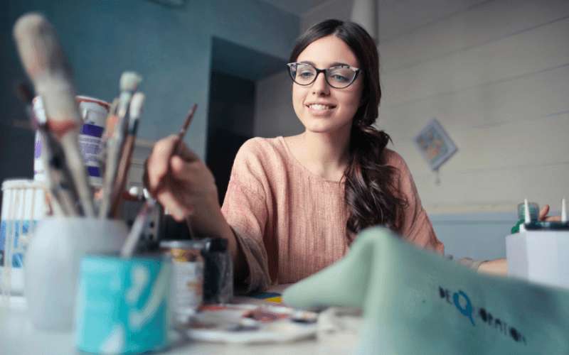 Photo of young woman painting