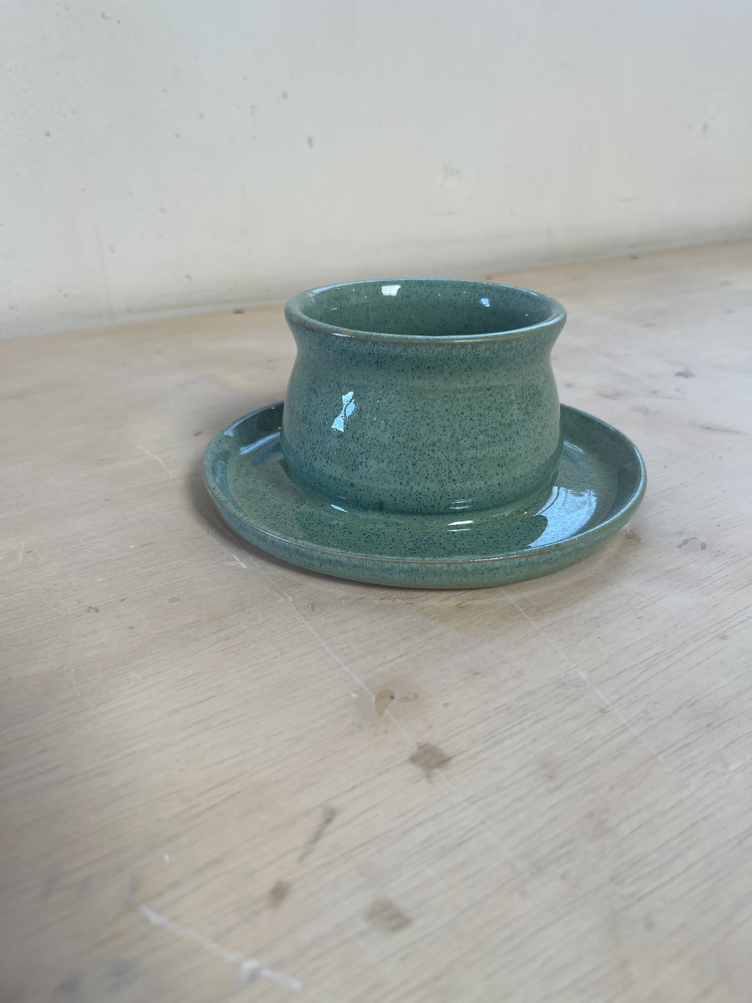 Wheel-thrown speckled green planter pot with built-in saucer