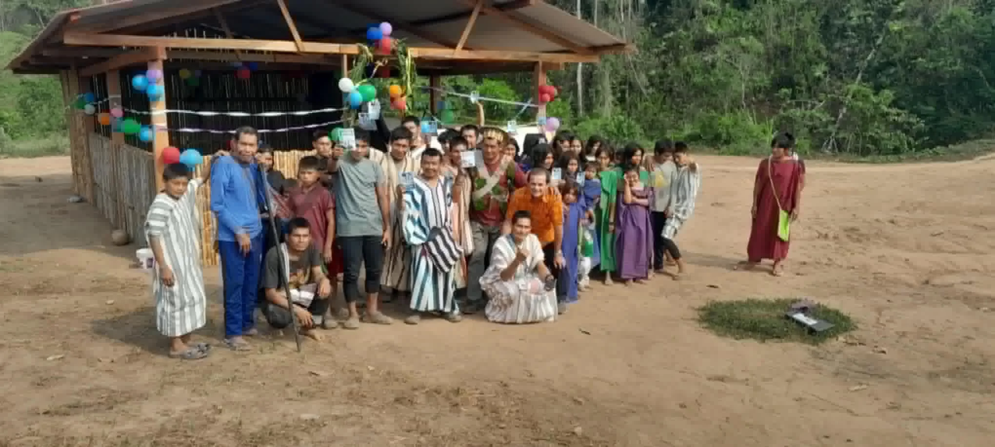 A community gathered outside a small wooden building, from Desiderio Escalante’s ministry photo album.