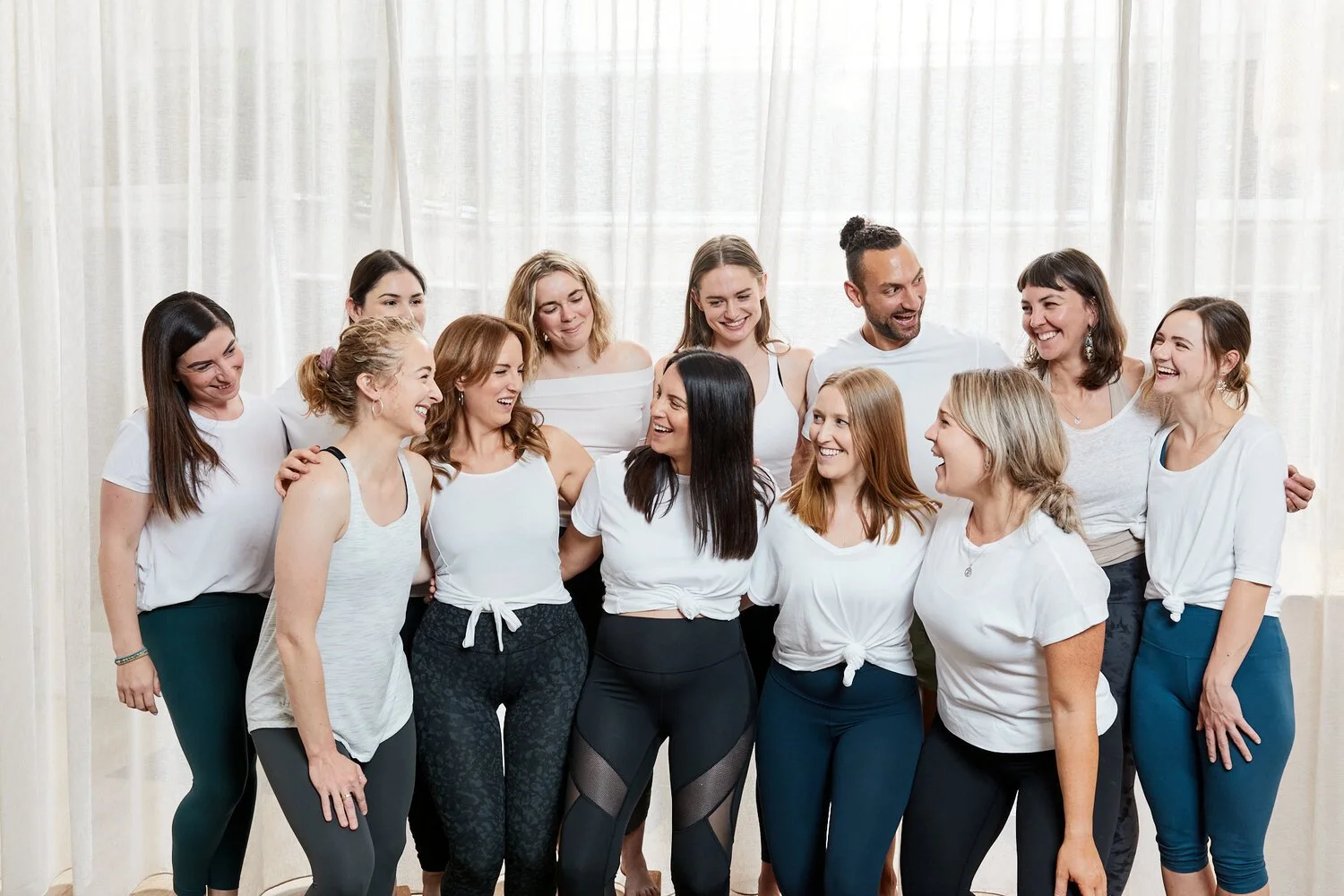 Oshun community in Reservoir Melbourne in activewear smiling and laughing indoors