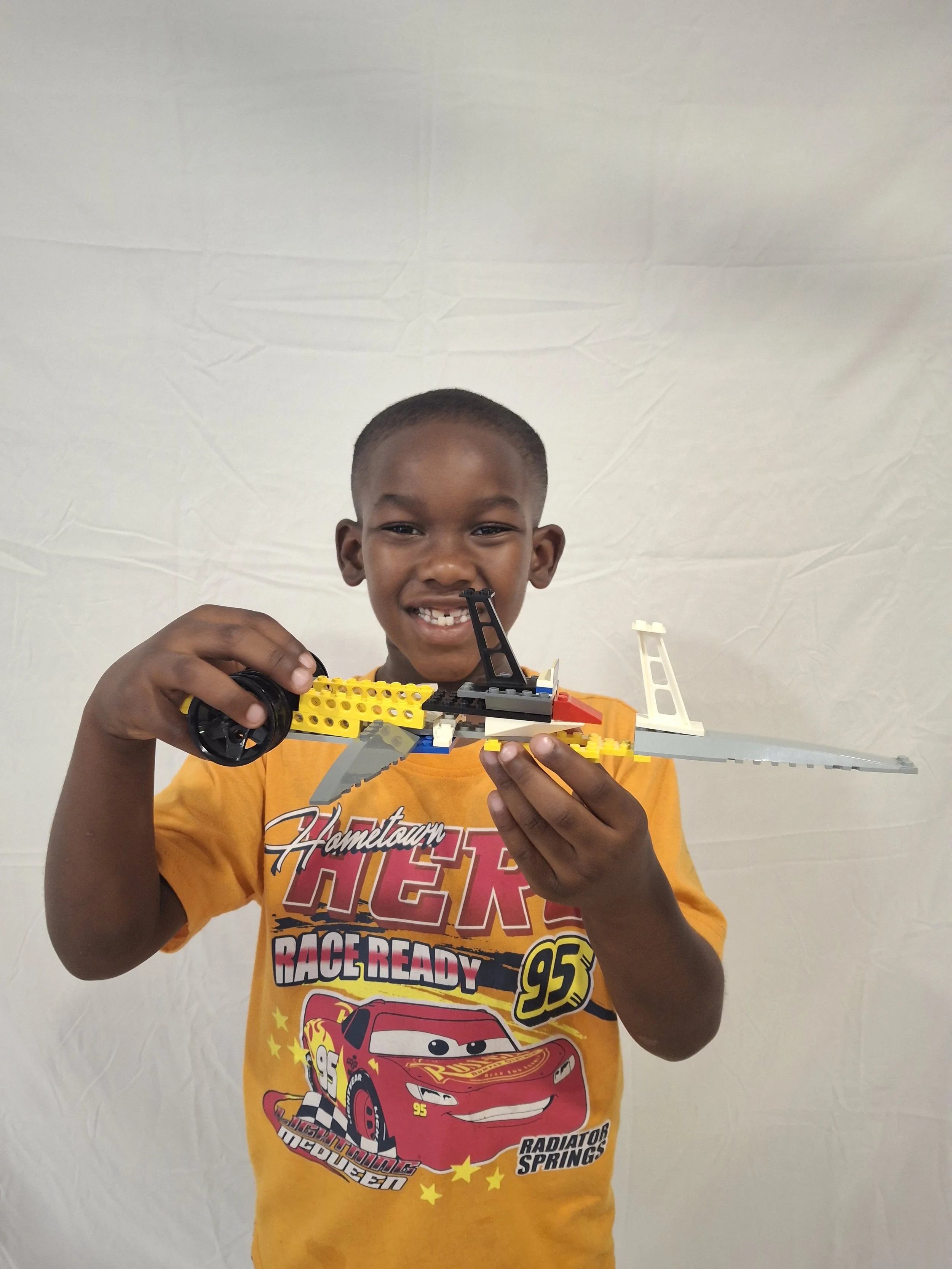 Camper builds a Lego aircraft