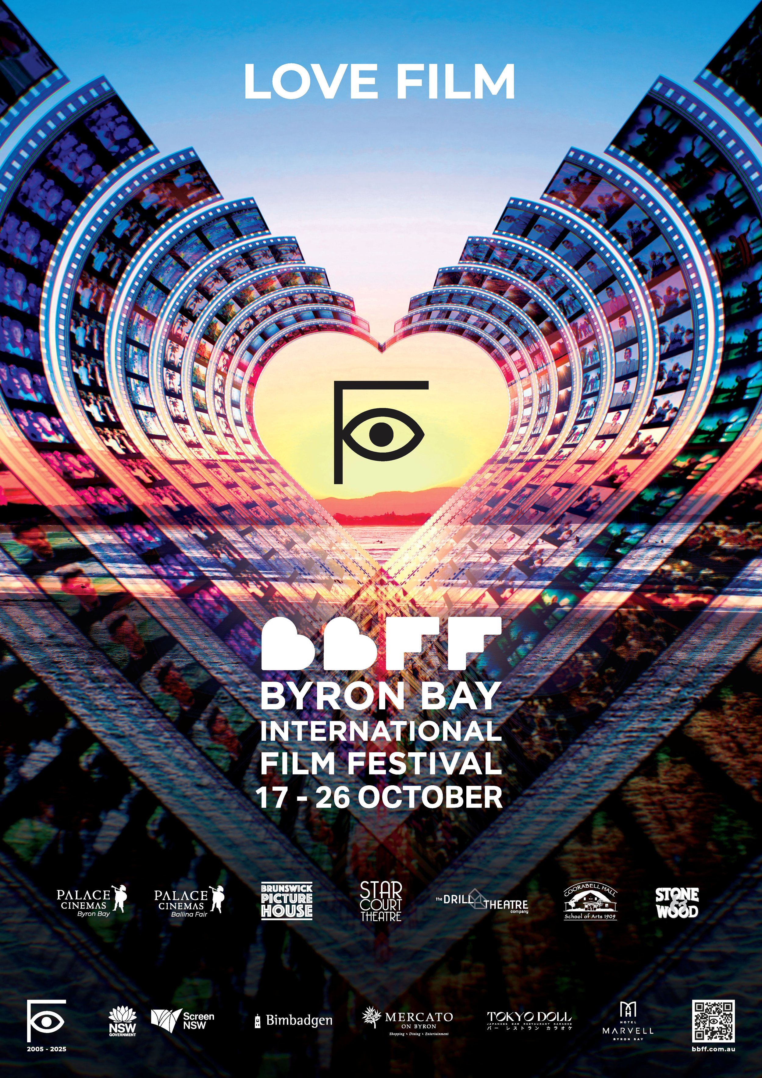 A heart made of film strips sits above the Byron Beach at sunset