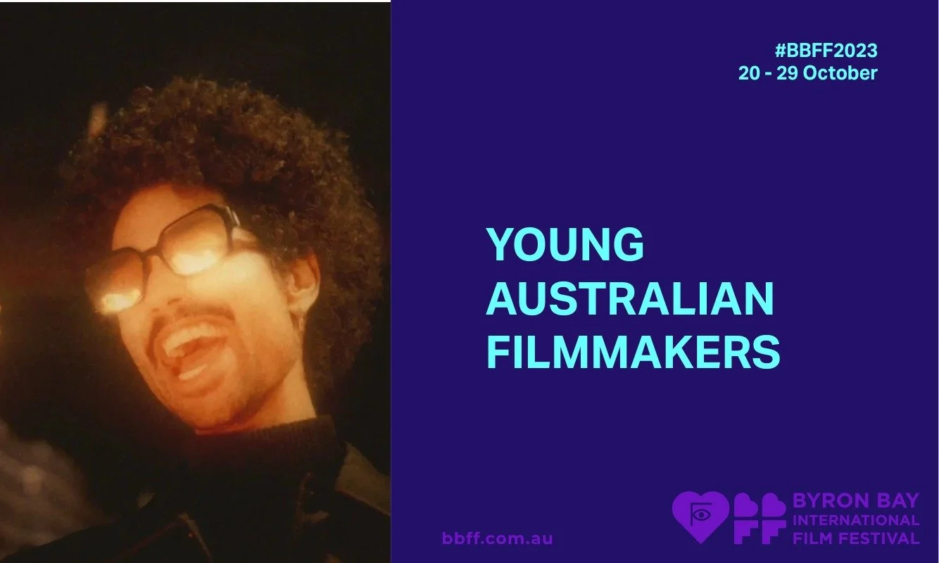A person with curly hair and sunglasses smiles warmly against a dark background. Text reads "Young Australian Filmmakers" alongside Byron Bay Film Festival details.