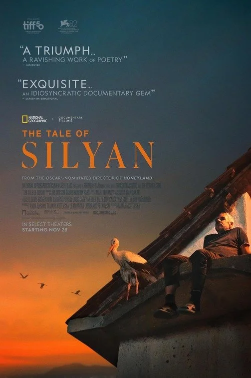 Movie poster for The Tale of Silyan. An elderly man sits on a rooftop at sunset beside a white stork, birds flying across an orange sky. Festival laurels for TIFF and Venice.