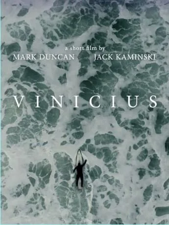 Overhead view of a lone surfer on a board amidst turbulent ocean waves, with text "a short film by Mark Duncan Jack Kaminski - Vinicius" overlaid.