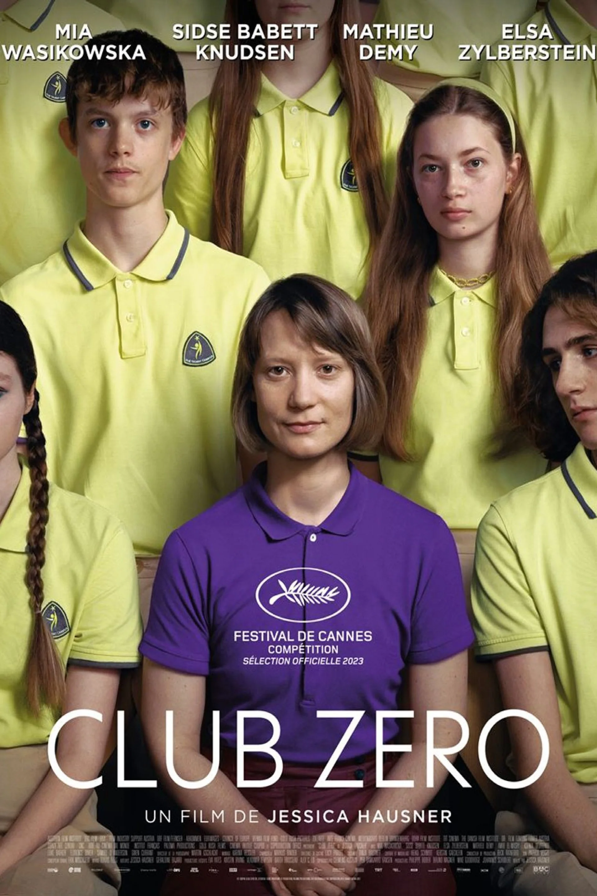 "Film poster for 'Club Zero' showing a group of people in yellow uniforms with one person in the center wearing a purple shirt, set against a neutral background. The Cannes Film Festival logo is displayed on the purple shirt. The mood is serious and 