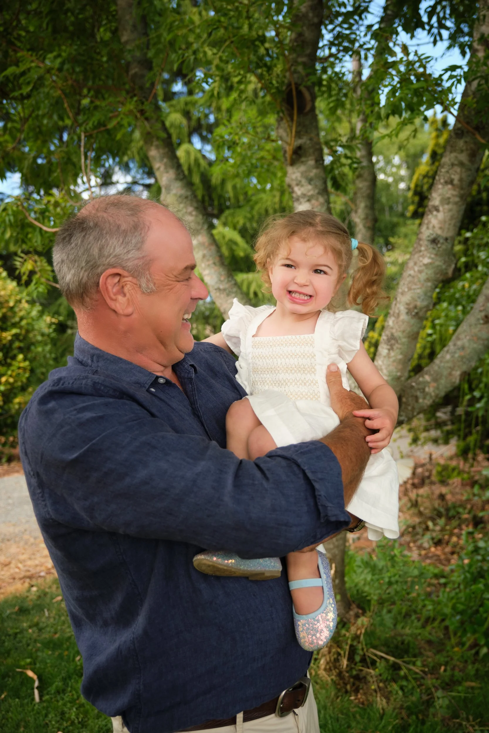 clark-launceston-extended-family-grandfather-holding-smiling-toddler-outdoors.jpeg