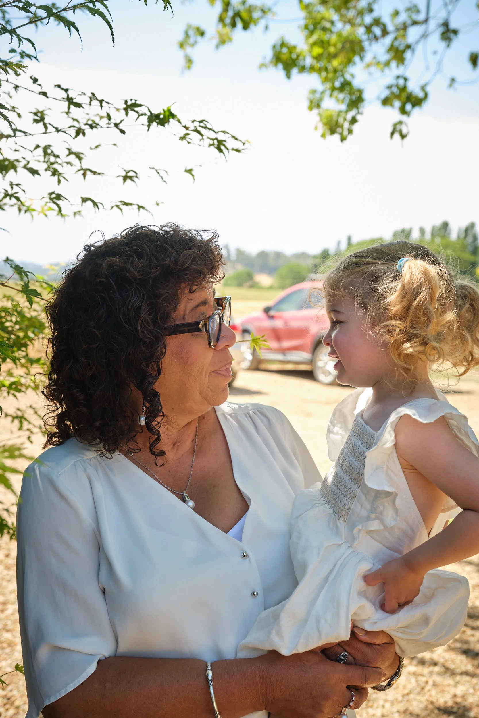 clark-launceston-extended-family-grandmother-holding-toddler-outdoors-smiling-interaction.jpeg