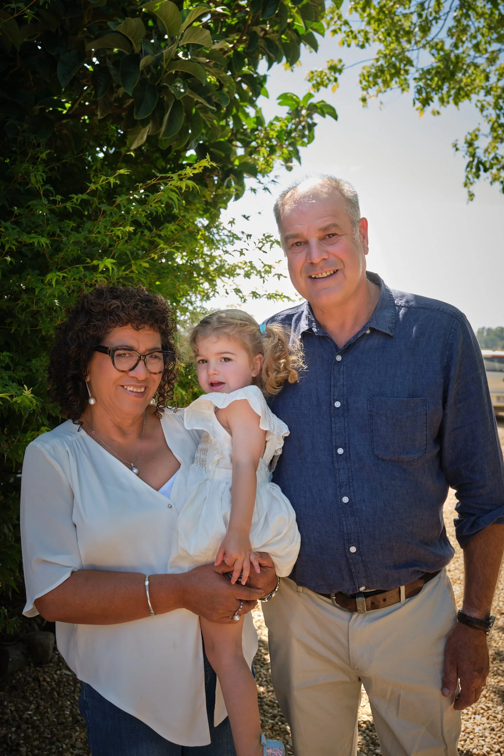 clark-launceston-extended-family-grandparents-holding-toddler-outdoor-garden.jpeg