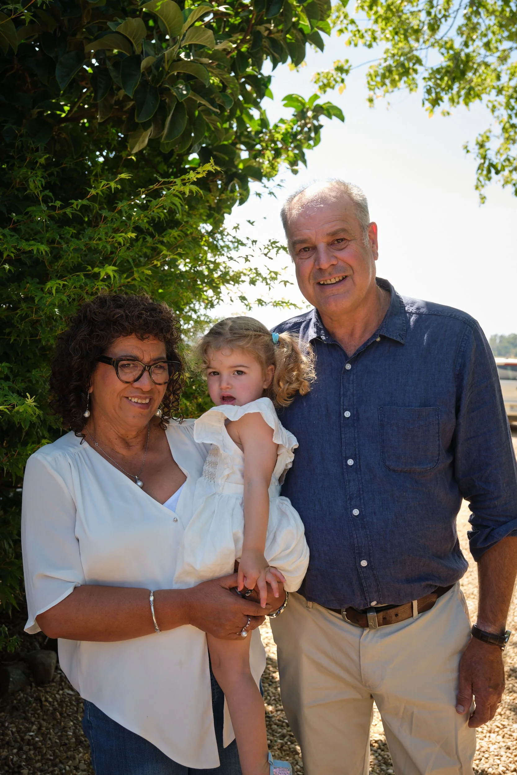 clark-launceston-extended-family-grandparents-holding-toddler-outdoors-smiling.jpeg