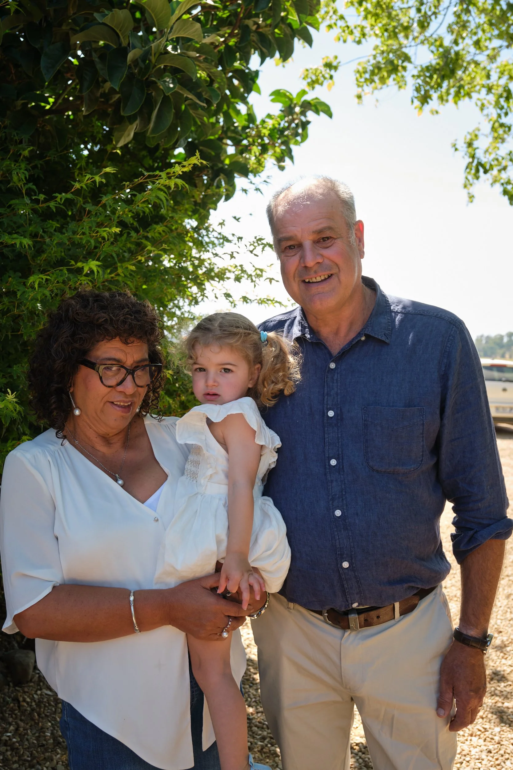 clark-launceston-extended-family-grandparents-holding-toddler-outdoors.jpeg