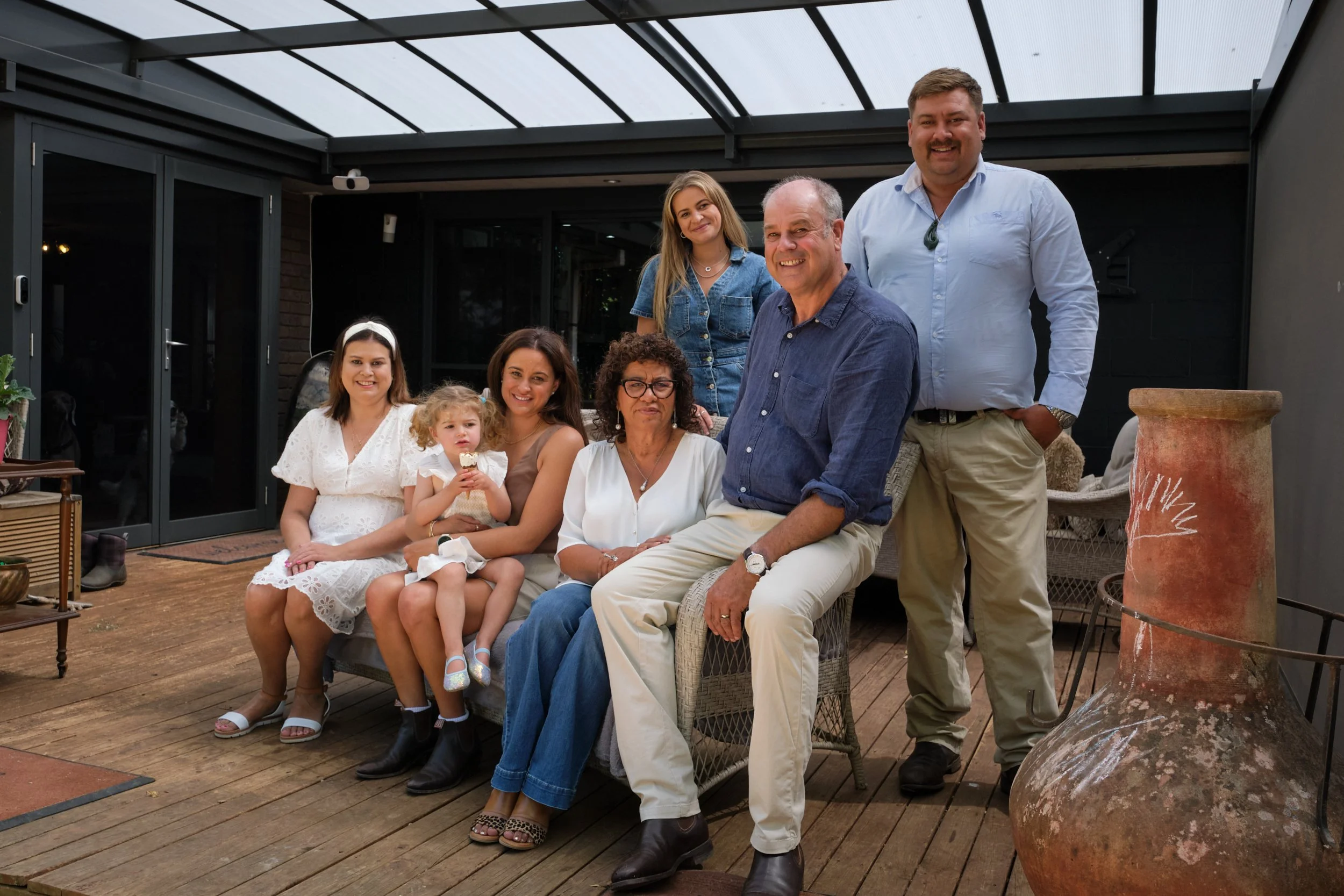clark-launceston-extended-family-home-porch-group-smiling-relaxed.jpeg