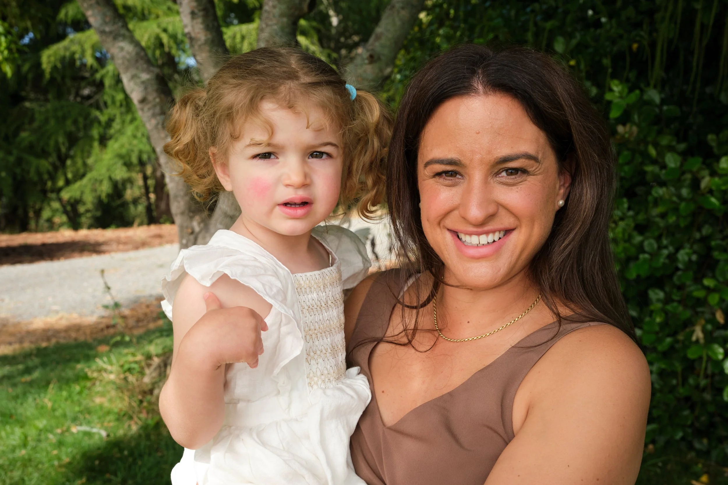 clark-launceston-extended-family-mum-holding-toddler-outdoor-smiling.jpeg