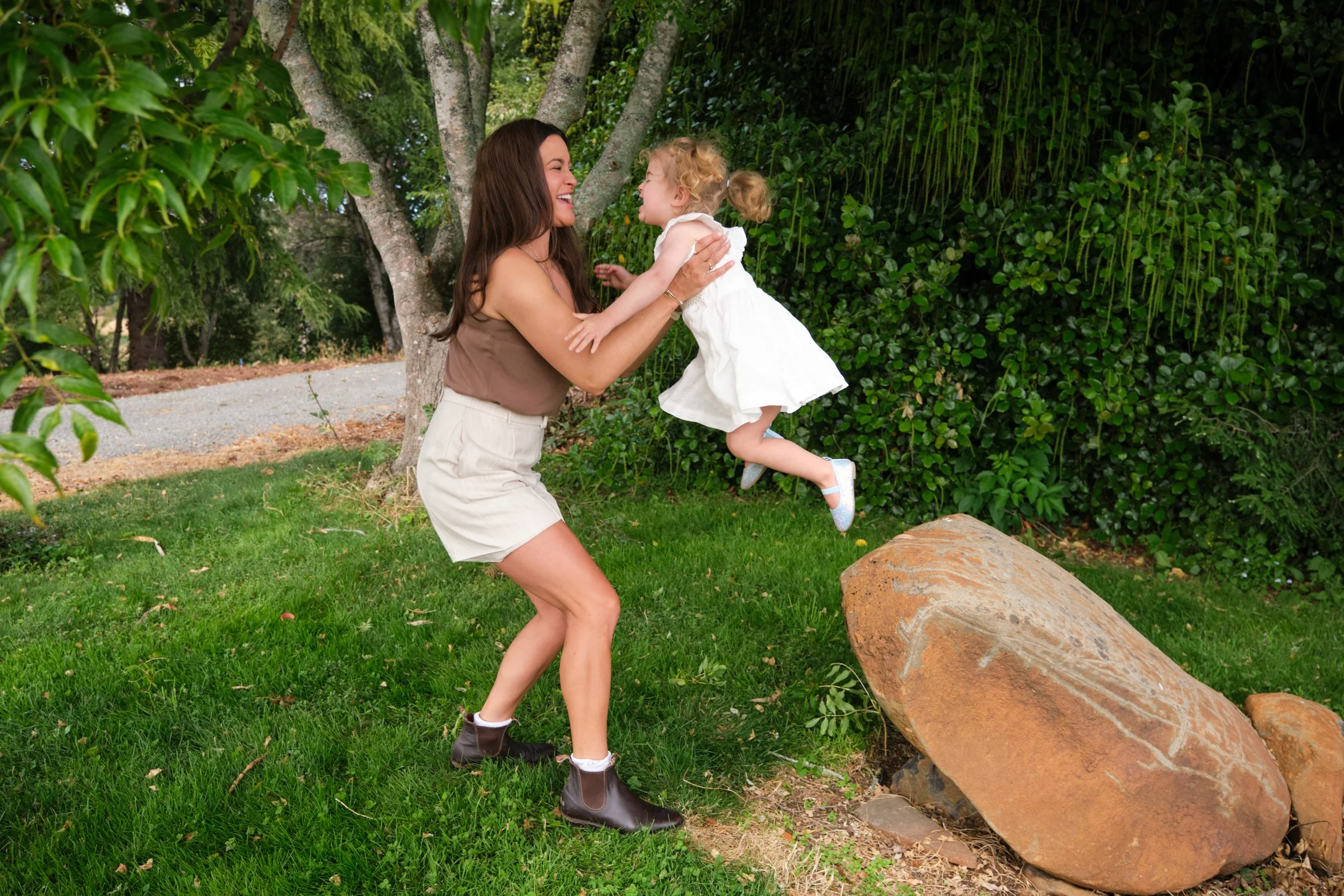 clark-launceston-extended-family-mum-lifting-toddler-outdoor-garden-play.jpeg