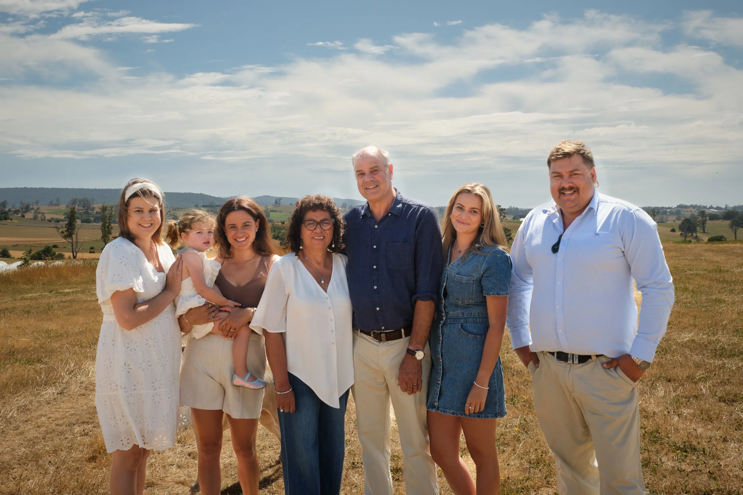 clark-launceston-extended-family-outdoor-portrait-on-farm-with-three-generations-smiling.jpeg