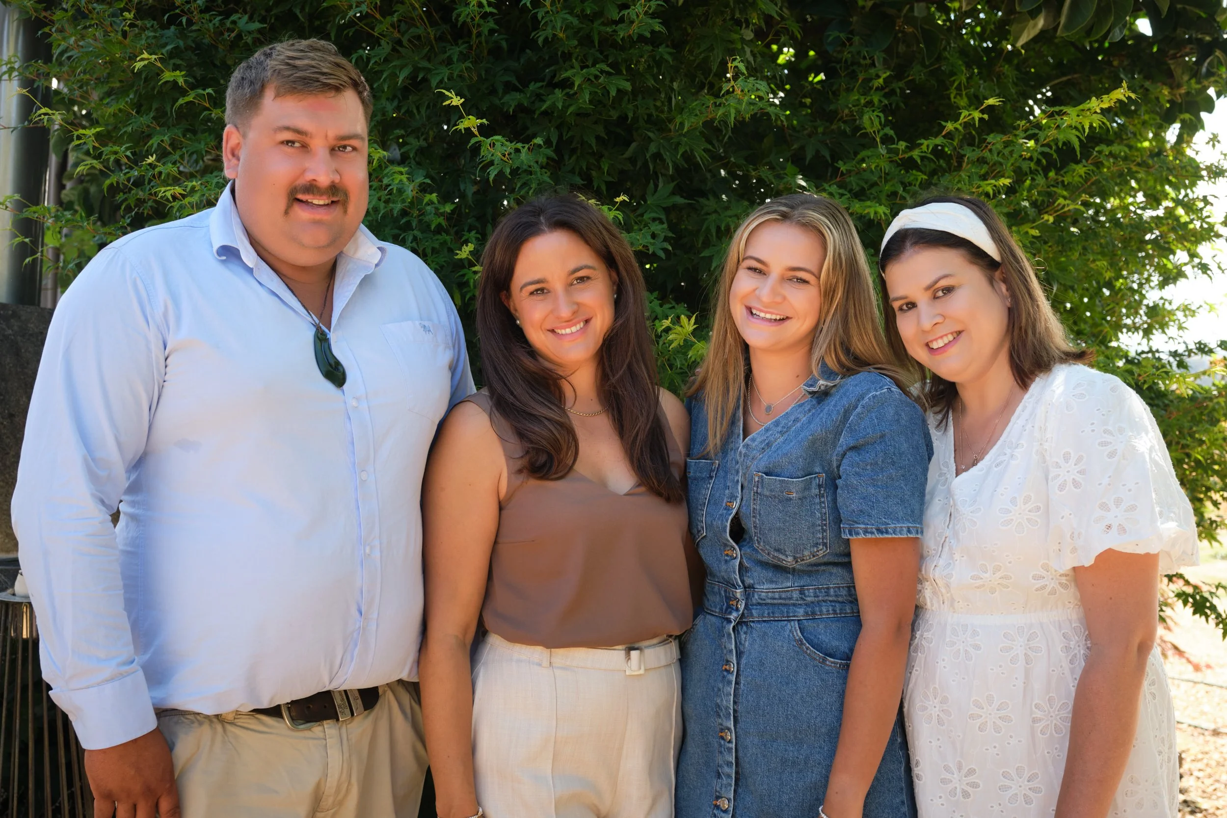 clark-launceston-extended-family-outdoor-portrait-smiling-group-under-green-trees.jpeg