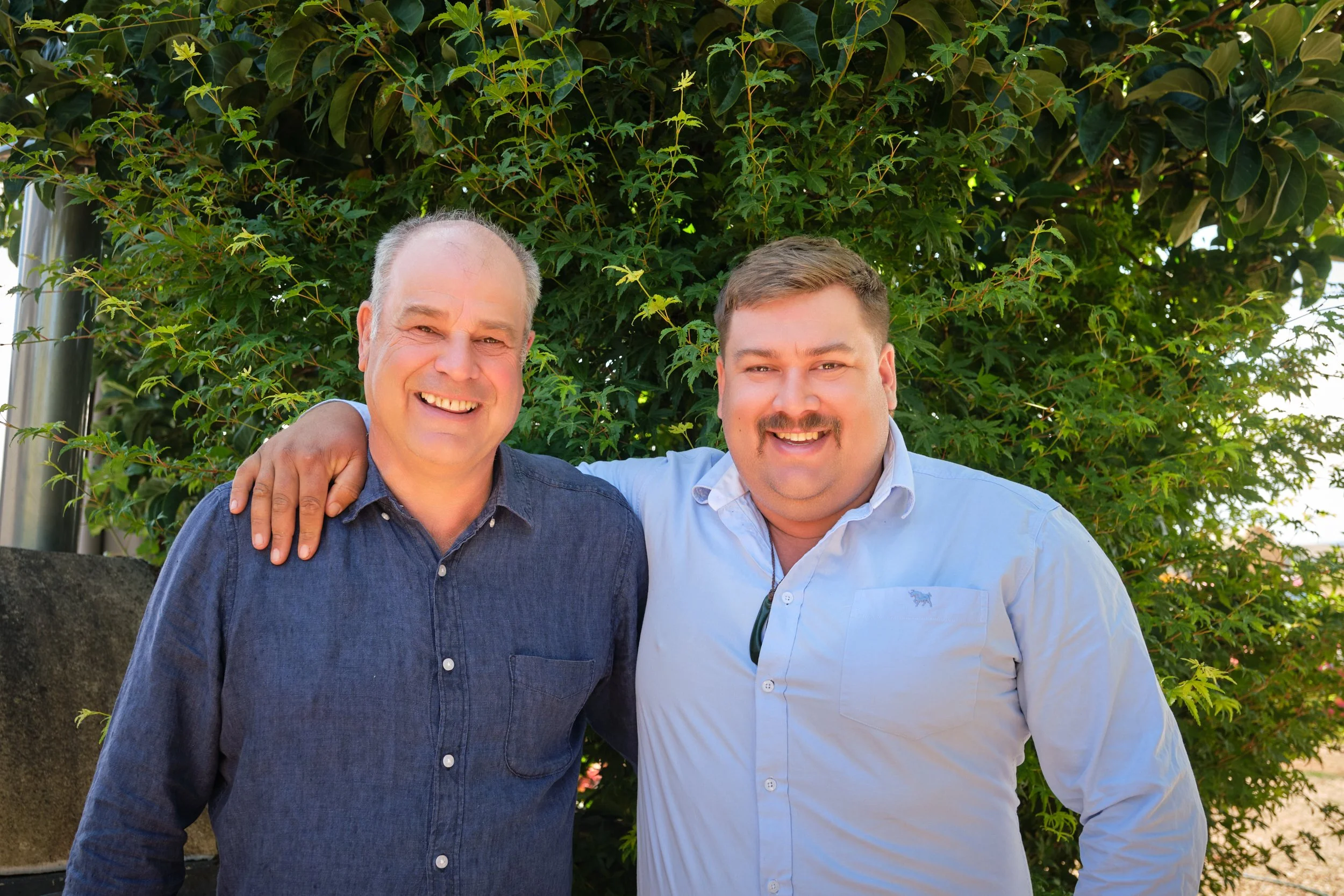 clark-launceston-extended-family-two-men-smiling-outdoor-portrait.jpeg