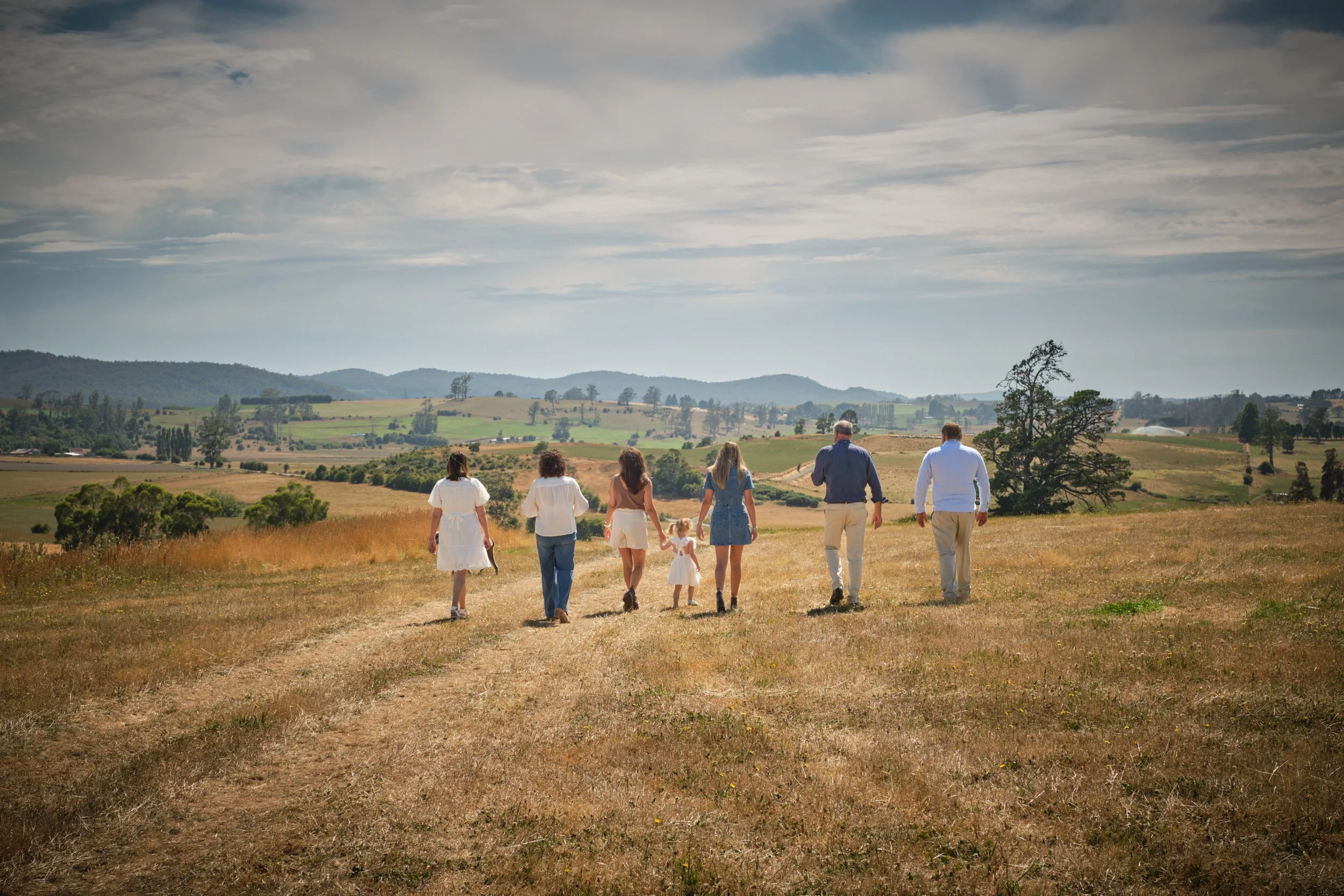 clark-launceston-extended-family-walking-across-farm-hills-together.jpeg