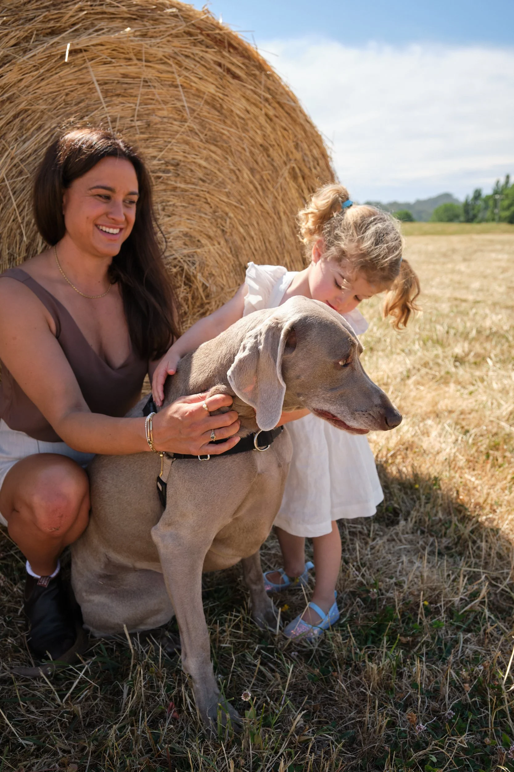 clark-launceston-extended-family-woman-girl-grey-dog-hay-bale-field.jpeg