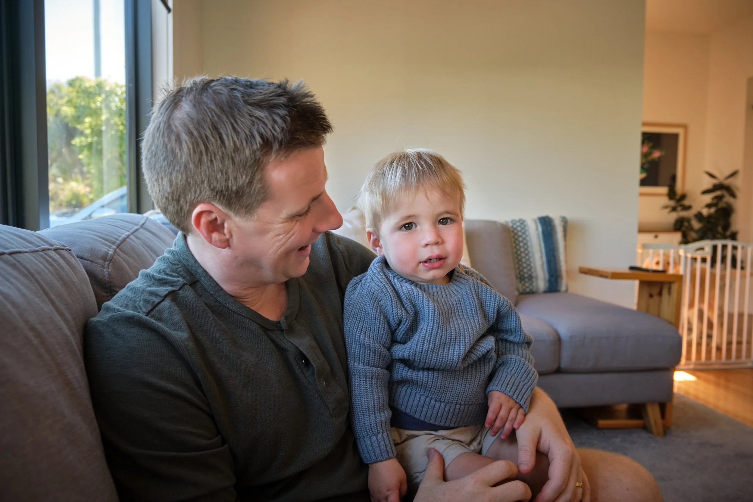 macdonald-launceston-family-portrait-father-holding-toddler-on-couch.jpeg