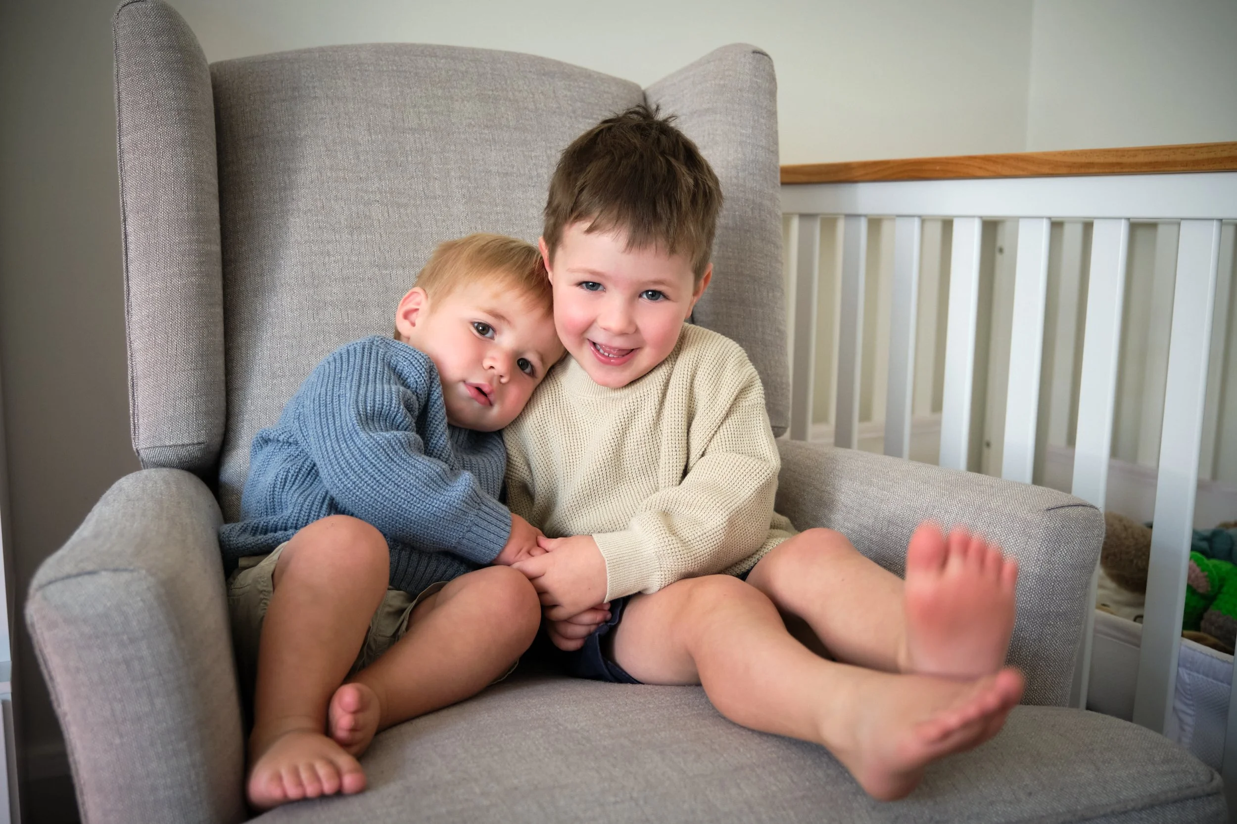 macdonald-launceston-family-portrait-two-brothers-cuddling-on-armchair-nursery.jpeg