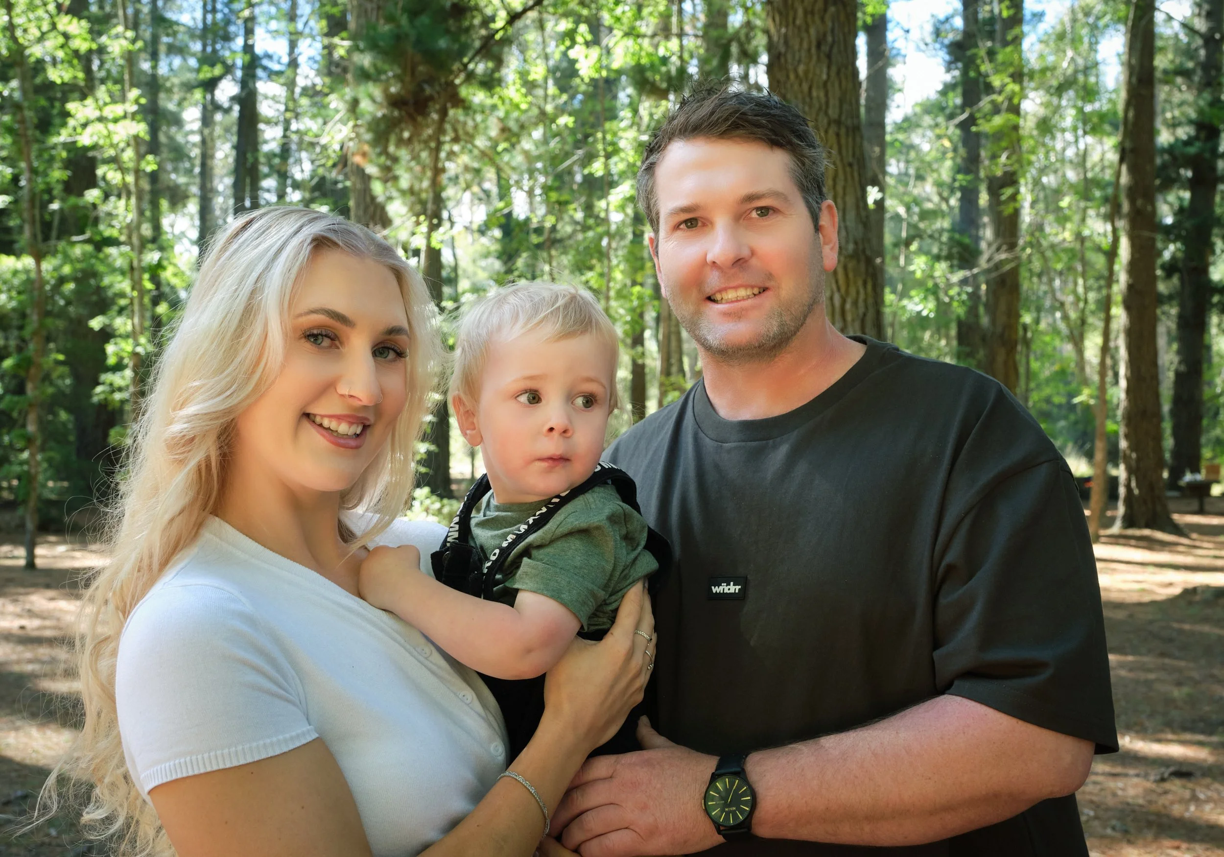 franks-hollybank-launceston-extended-family-portrait-young-parents-holding-toddler-in-forest.jpeg