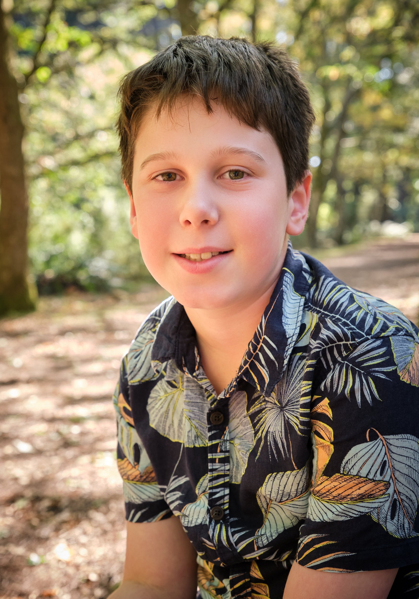 woods-hollybank-launceston-extended-family-photography-young-boy-smiling-forest-path.jpeg