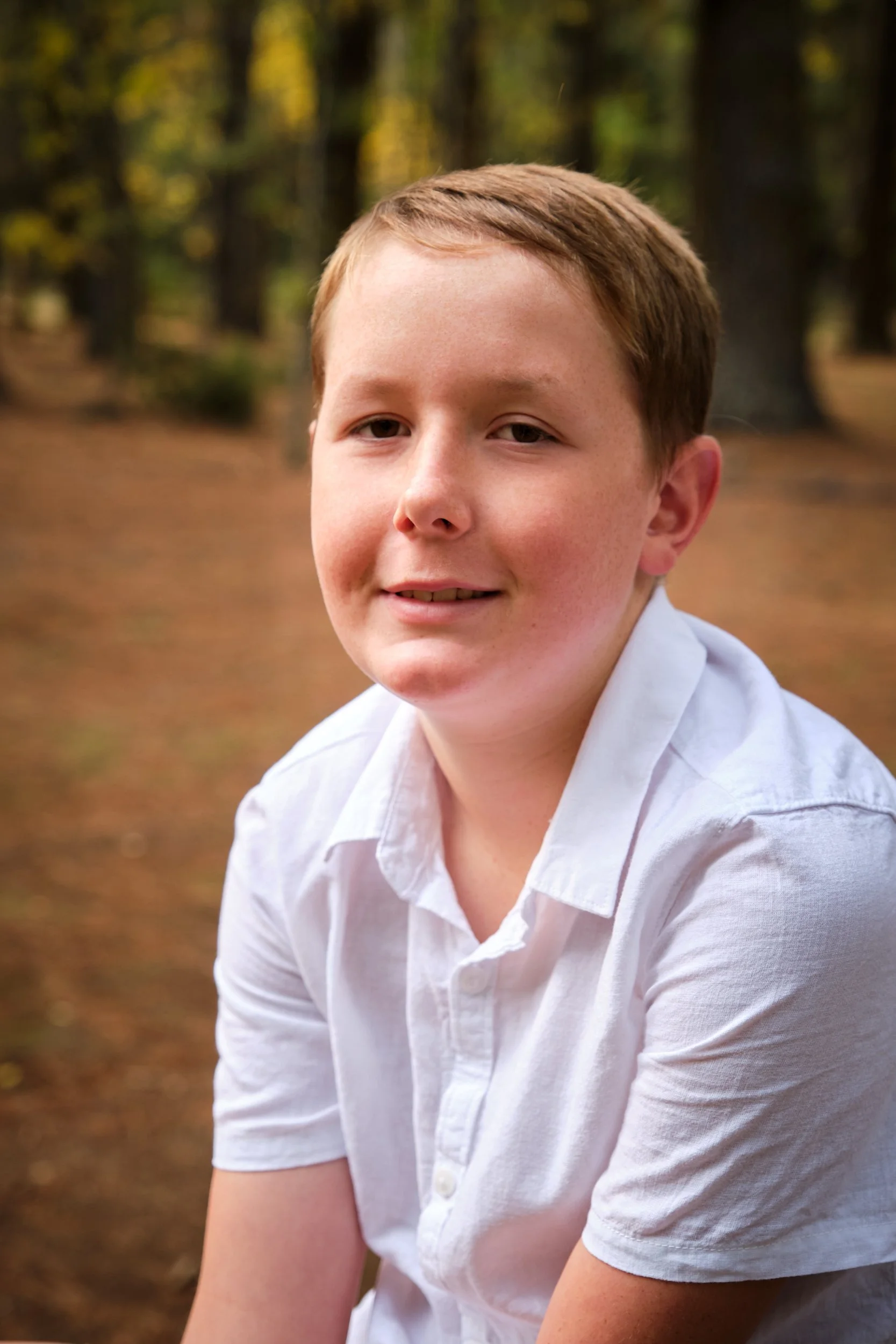 north-hollybank-launceston-family-photography-boy-in-white-shirt-in-forest.jpeg