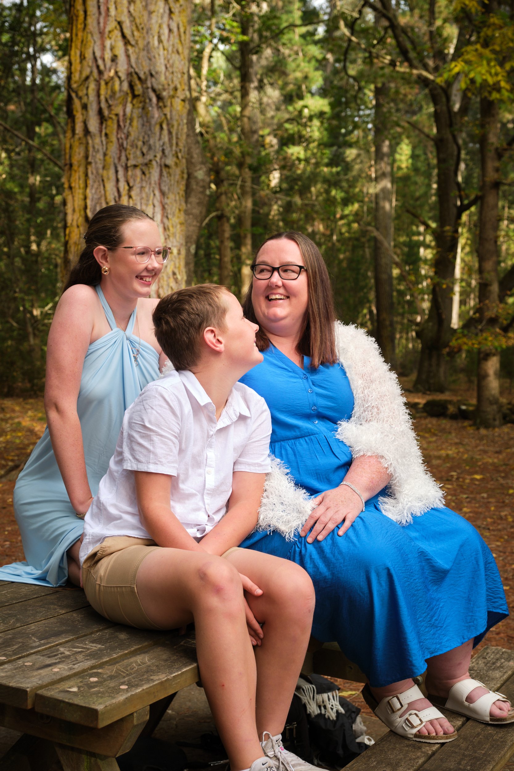 north-hollybank-launceston-family-photography-mum-with-kids-laughing-on-forest-bench.jpeg