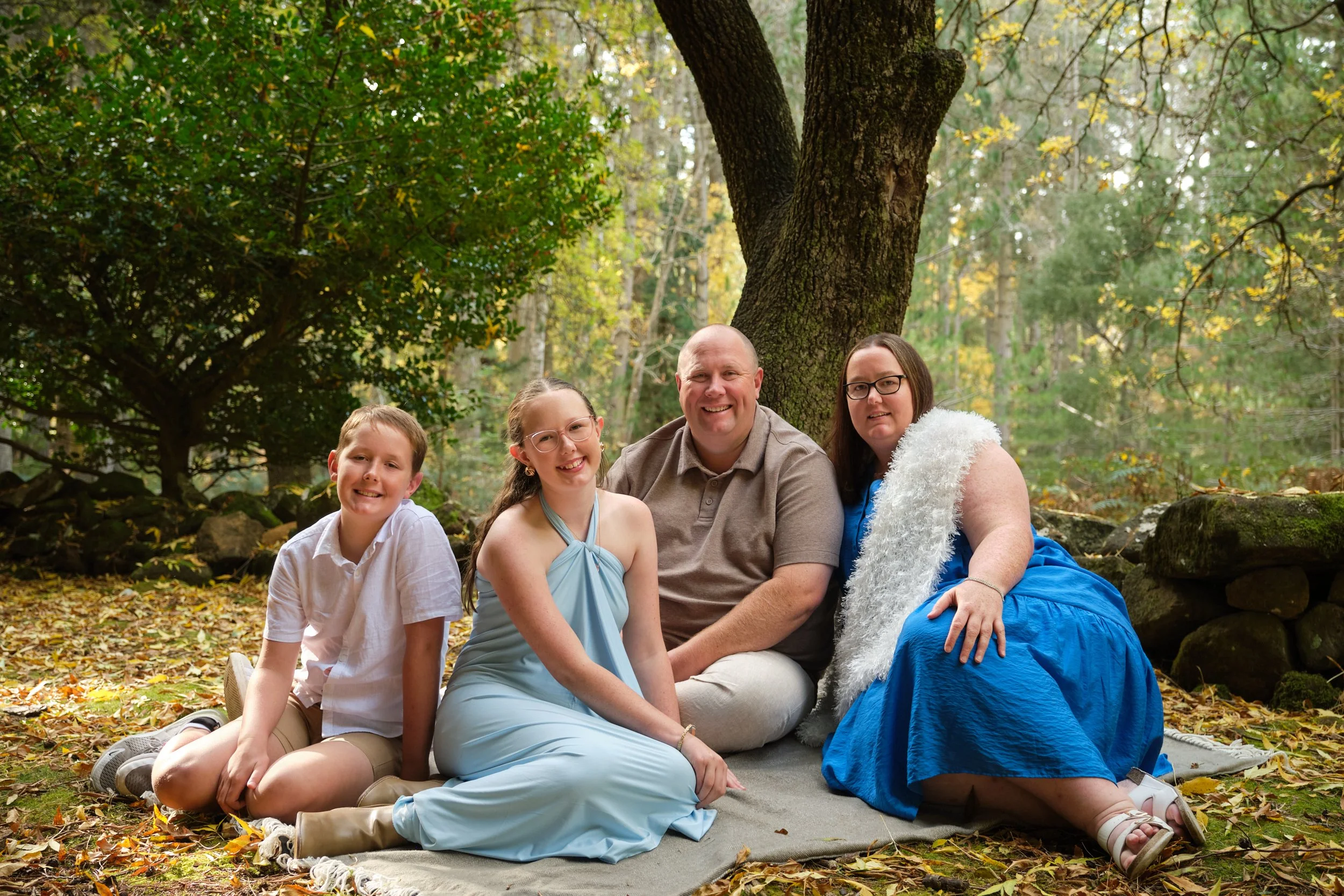 north-hollybank-launceston-family-photography-outdoor-forest-portrait-smiling-family-sitting-under-tree.jpeg