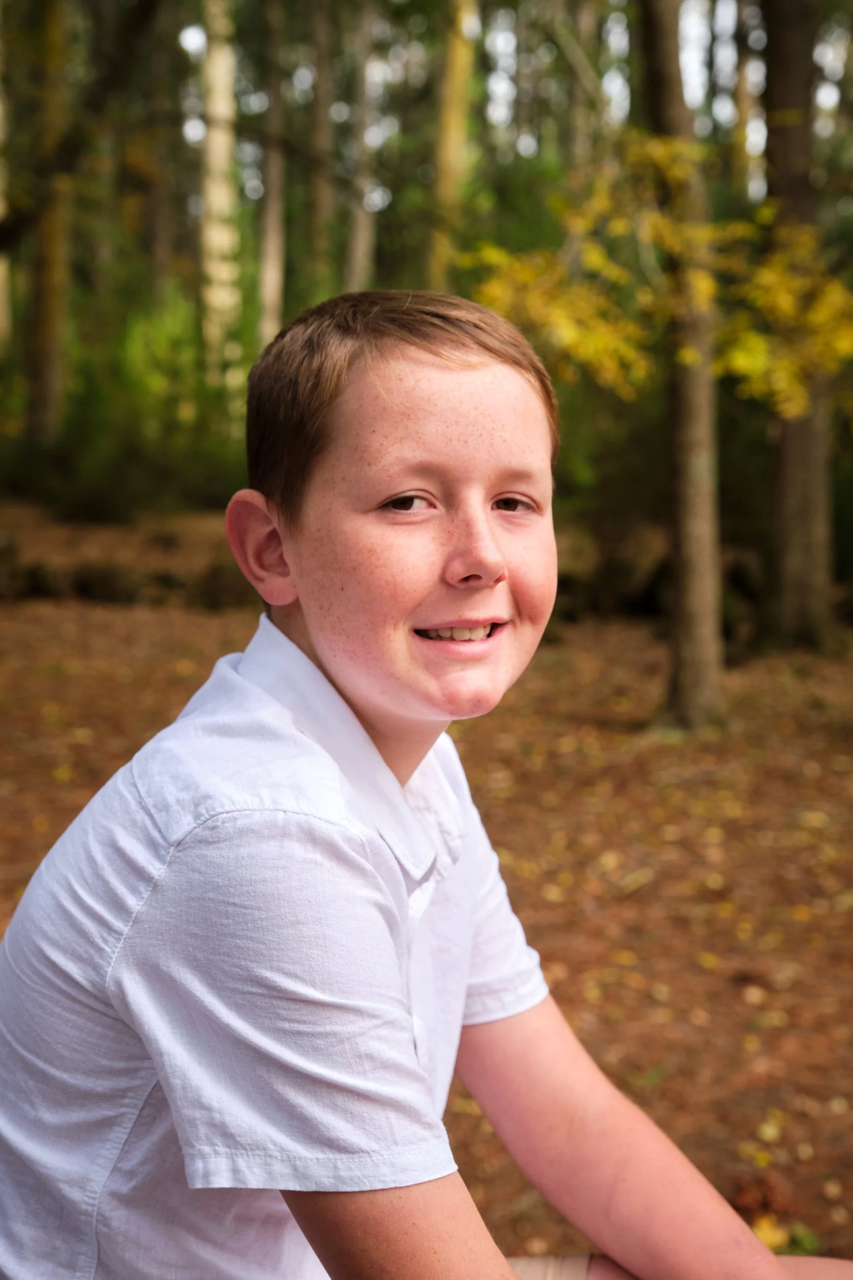 north-hollybank-launceston-family-photography-teen-boy-smiling-in-forest.jpeg