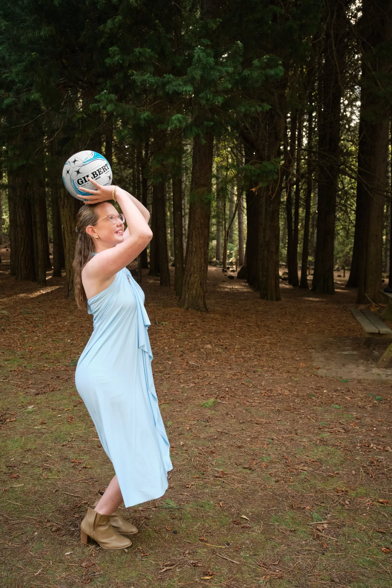north-hollybank-launceston-family-photography-woman-holding-netball-in-forest.jpeg