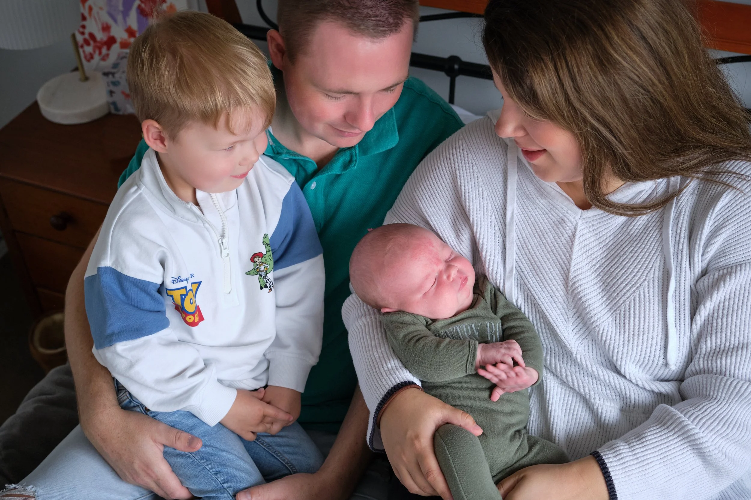 lawrence-launceston-newborn-family-photography-parents-cuddling-toddler-and-newborn-at-home.jpeg