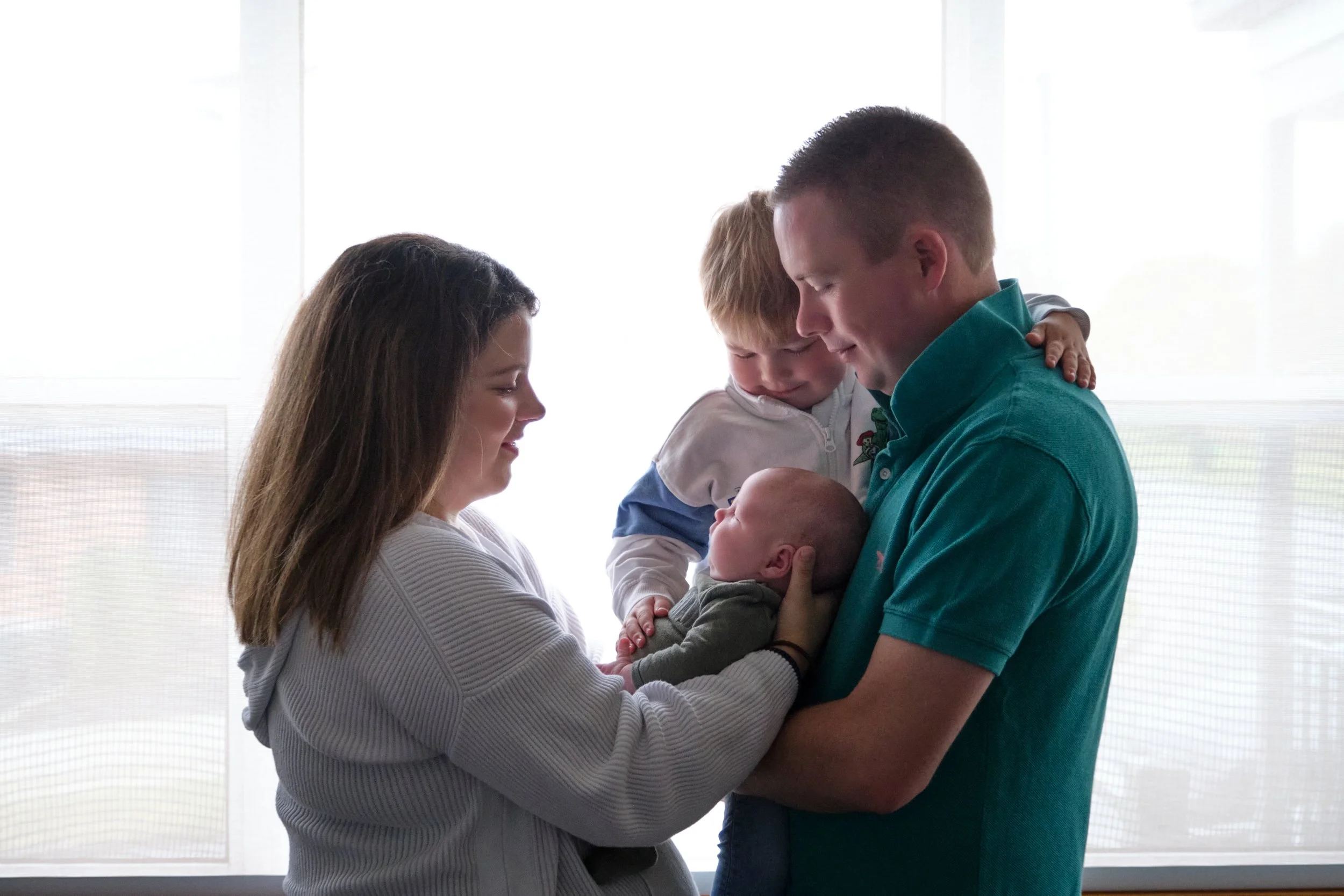 lawrence-launceston-newborn-family-photography-parents-holding-baby-with-toddler.jpeg