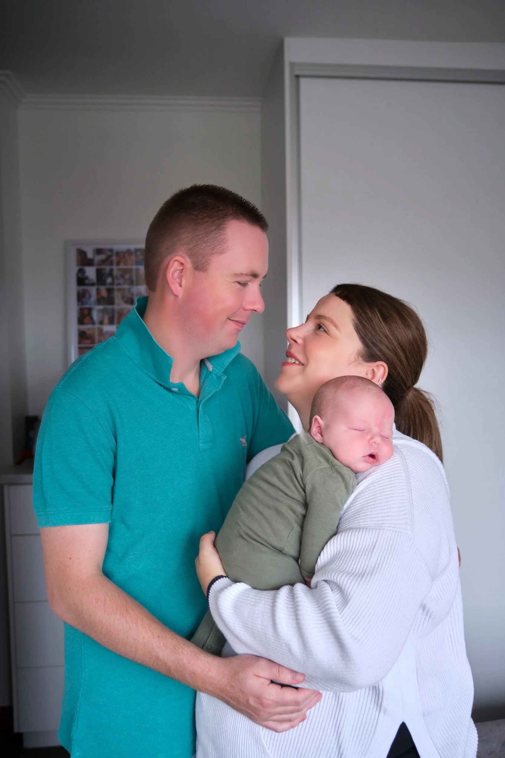 lawrence-launceston-newborn-family-photography-parents-holding-sleeping-baby-at-home.jpeg