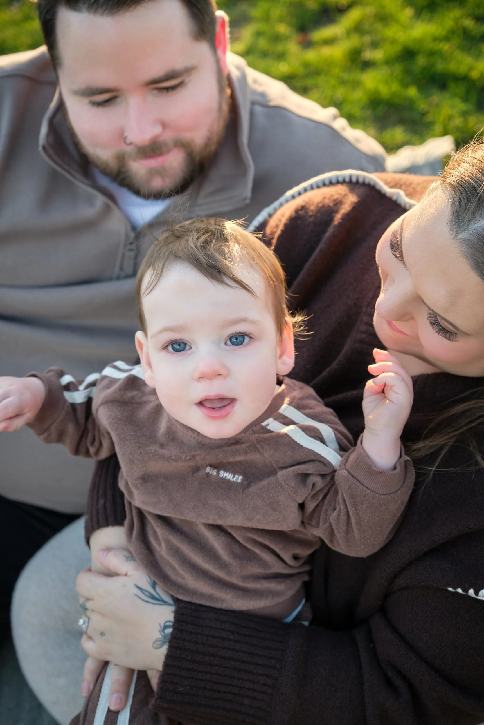 williams-hadspen-river-launceston-family-portrait-baby-with-parents-smiling-outdoors.jpeg