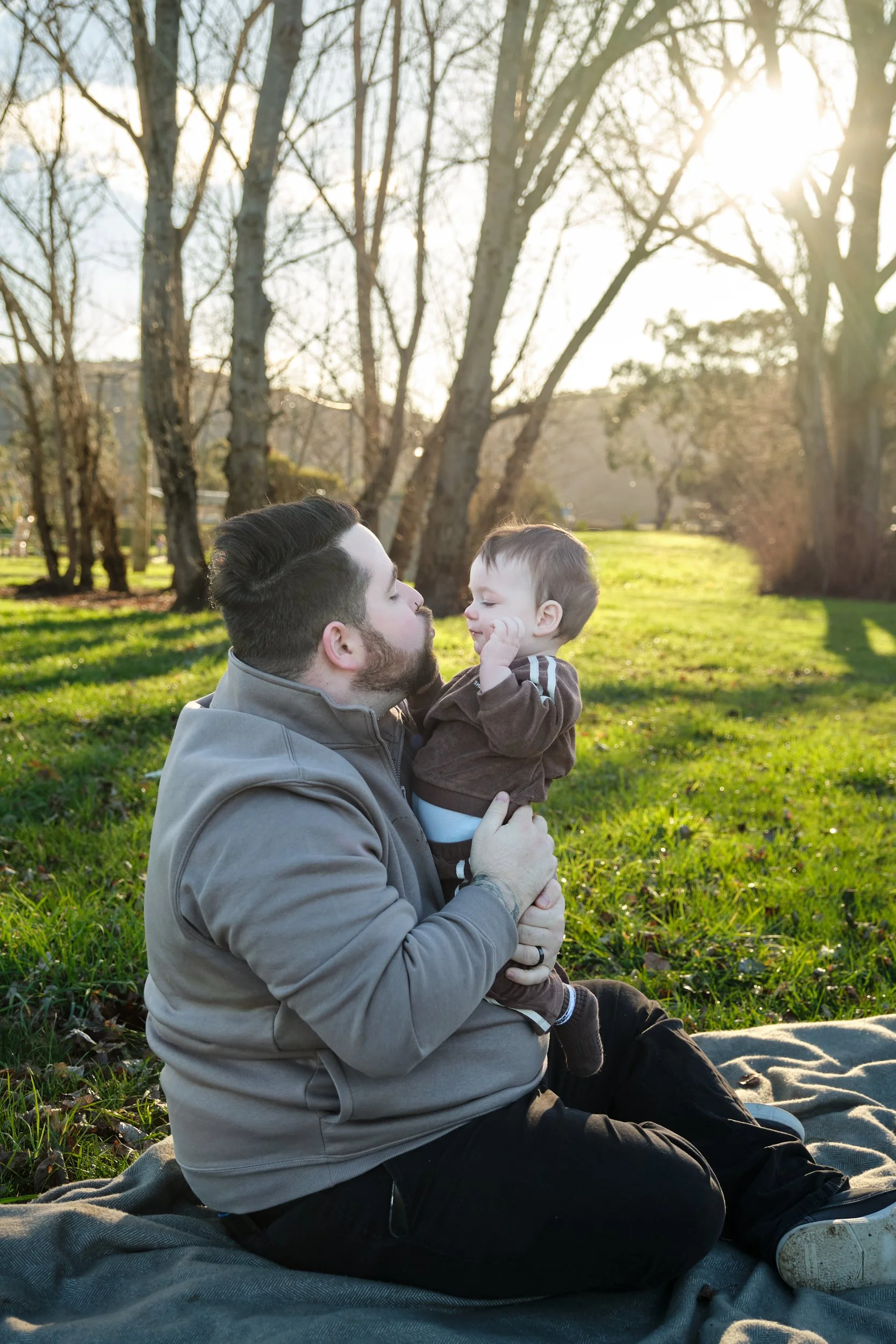 williams-hadspen-river-launceston-family-portrait-father-holding-baby-at-sunset.jpeg