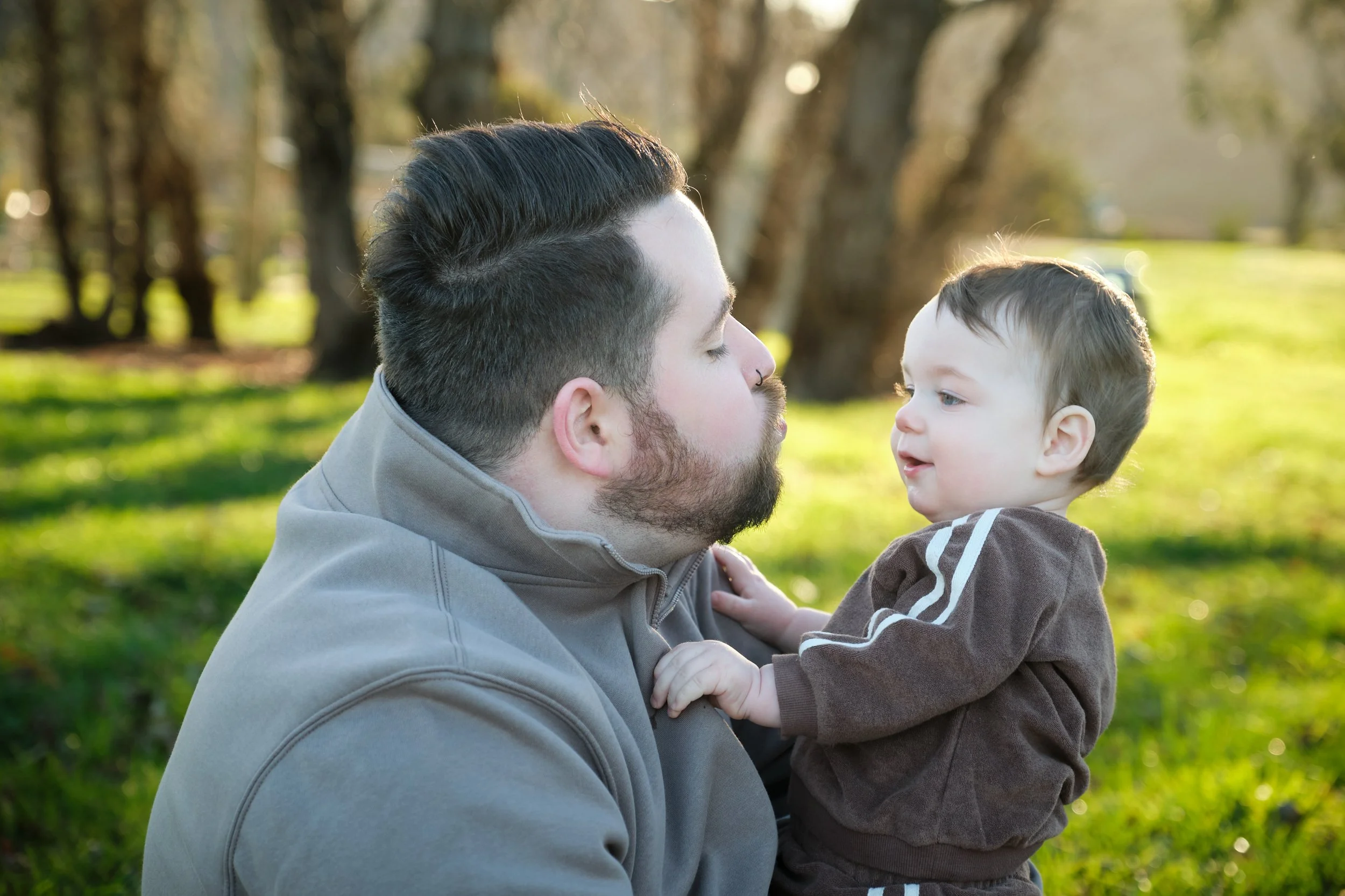 williams-hadspen-river-launceston-family-portrait-father-holding-baby-outdoors.jpeg