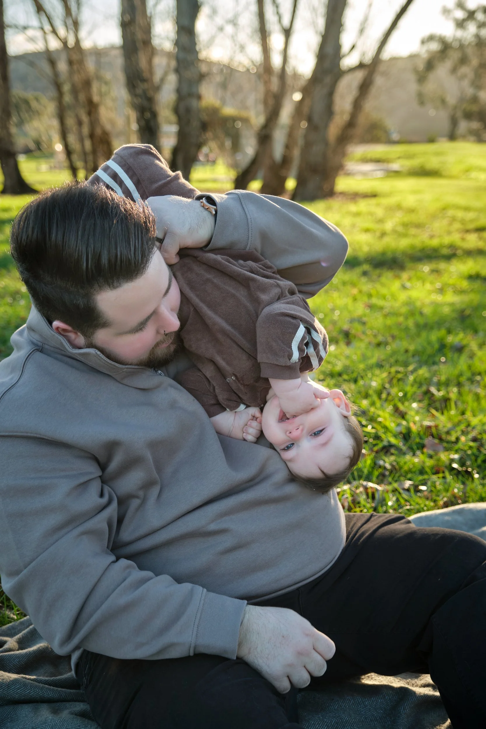 williams-hadspen-river-launceston-family-portrait-father-playing-upside-down-baby.jpeg