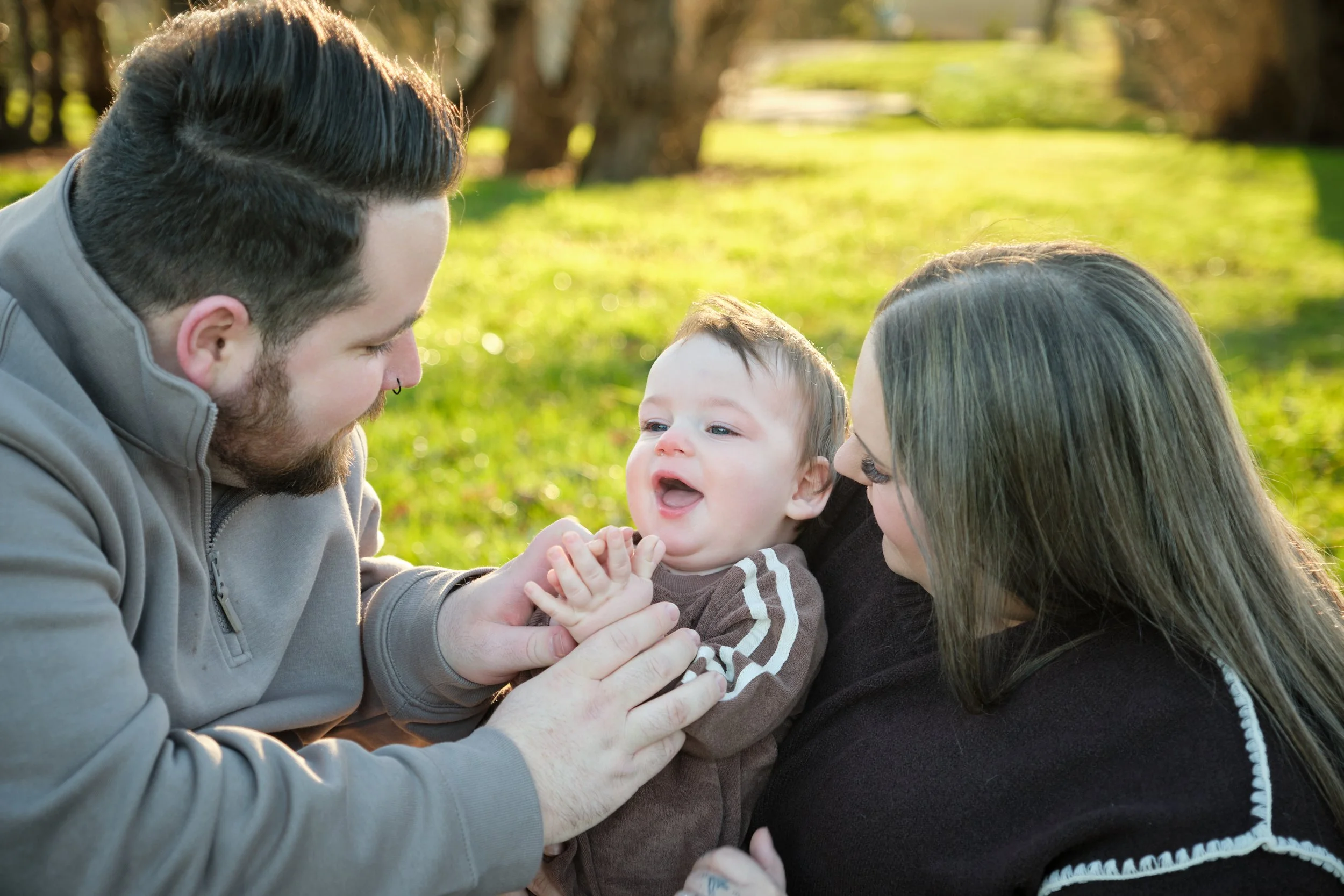 williams-hadspen-river-launceston-family-portrait-session-parents-playing-with-smiling-baby.jpeg