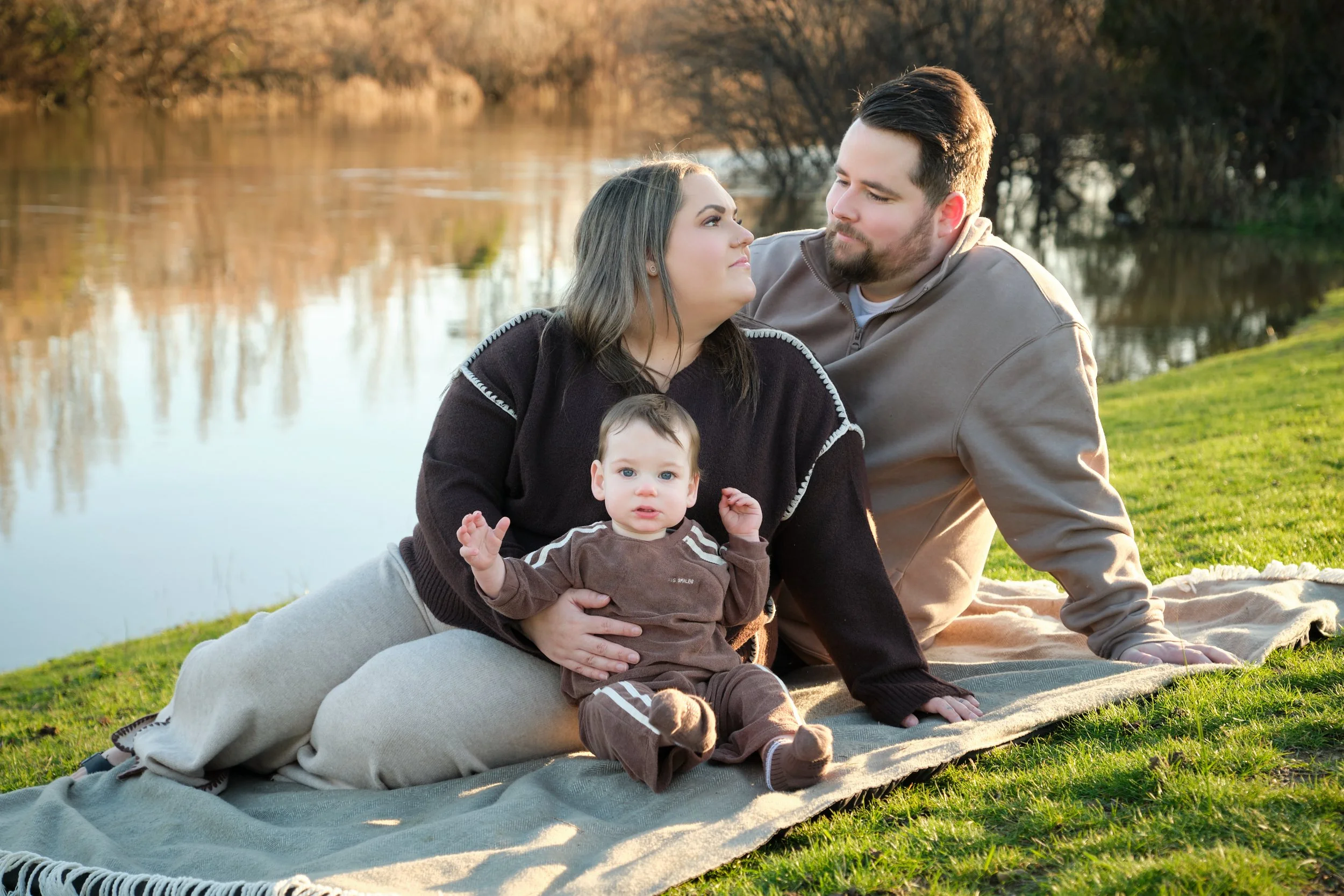 williams-hadspen-river-launceston-family-portrait-session-parents-sitting-with-baby-on-blanket.jpeg