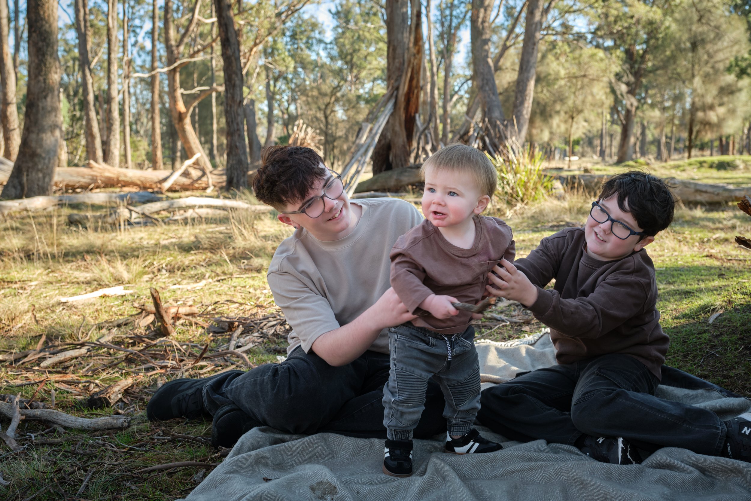 bennett-trevallyn-reserve-launceston-family-photography-brothers-playing-with-toddler-in-forest.jpeg