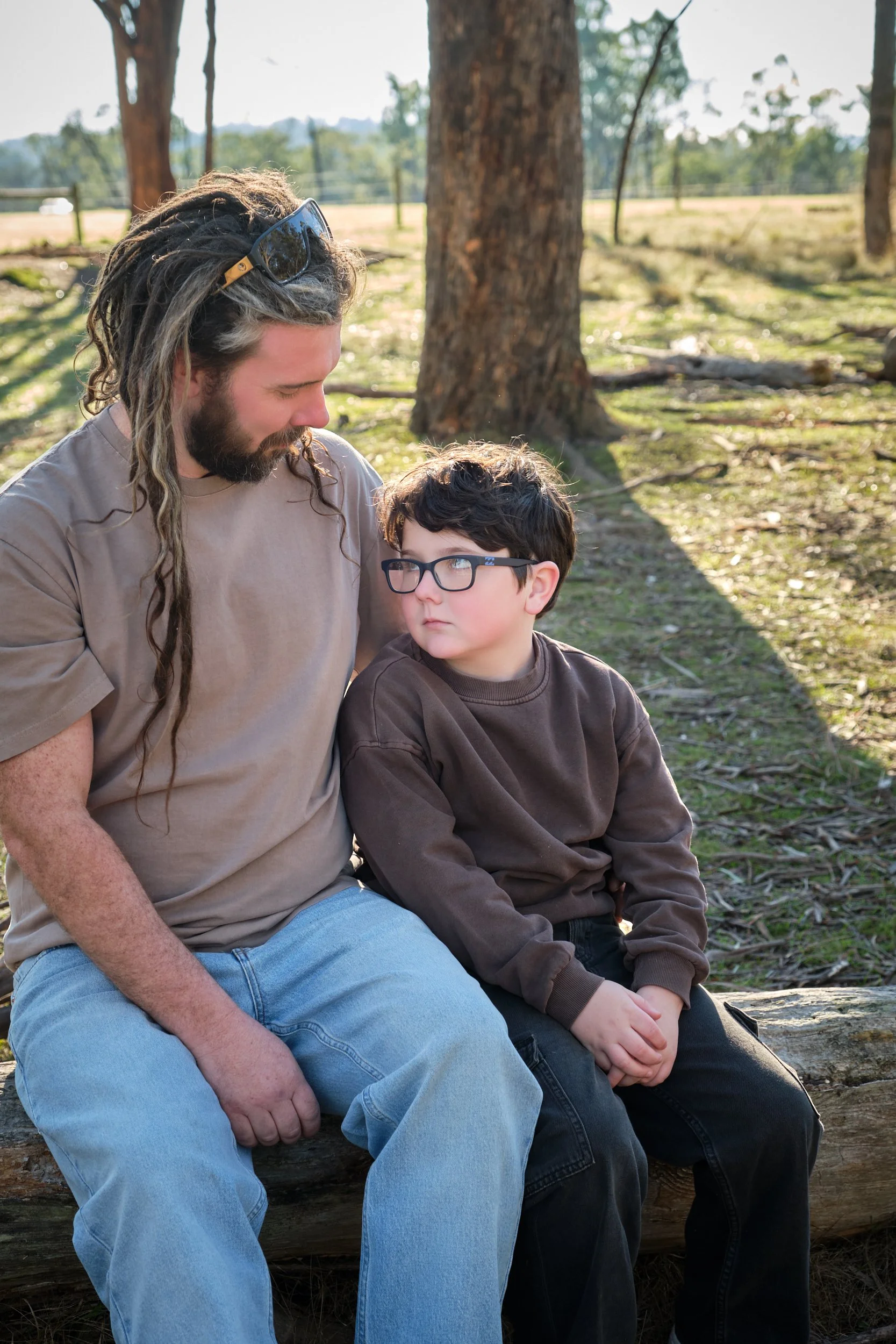 bennett-trevallyn-reserve-launceston-family-photography-father-son-sitting-log-outdoors.jpeg