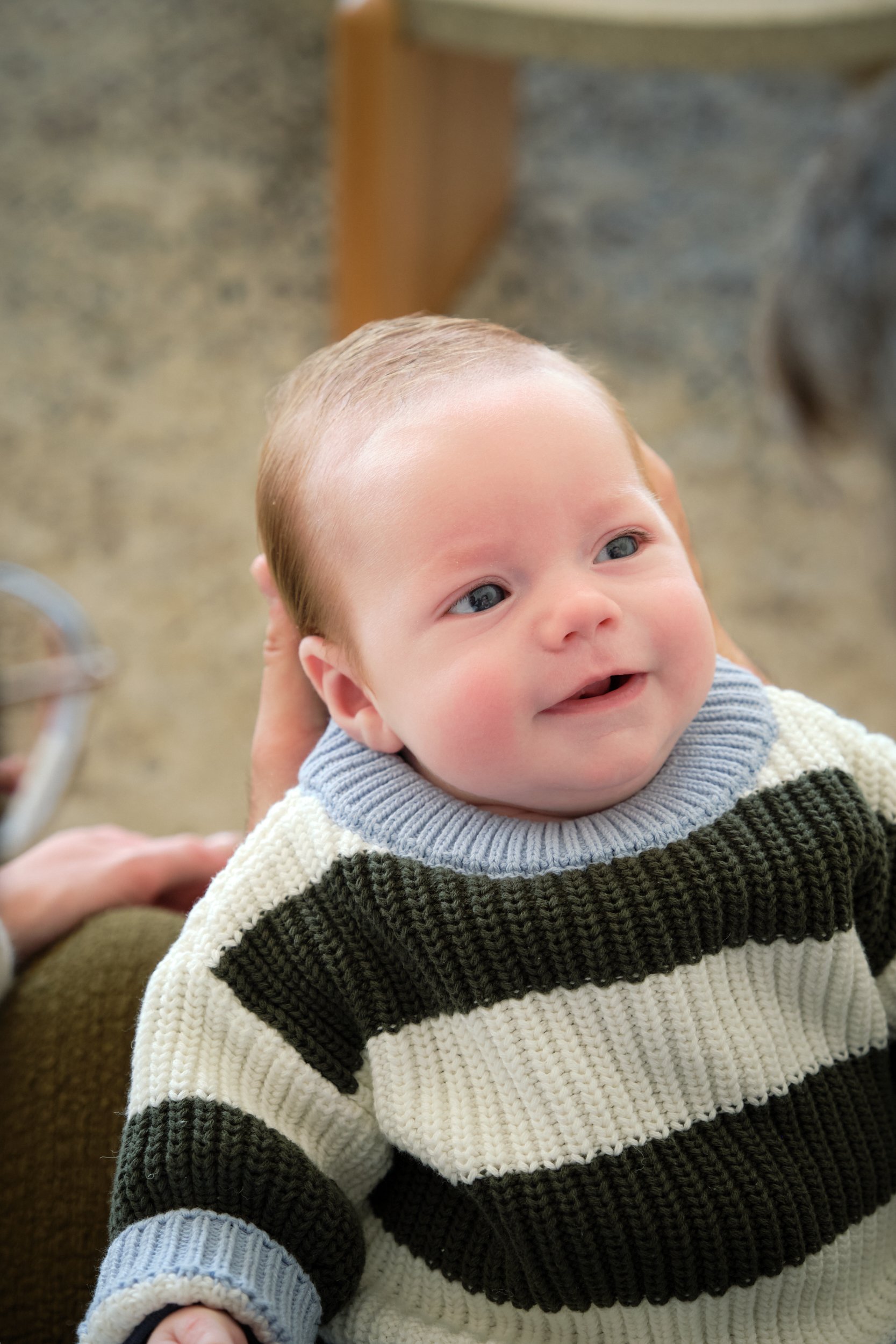 hill-launceston-newborn-family-photography-baby-smiling-in-striped-knit-sweater.jpeg