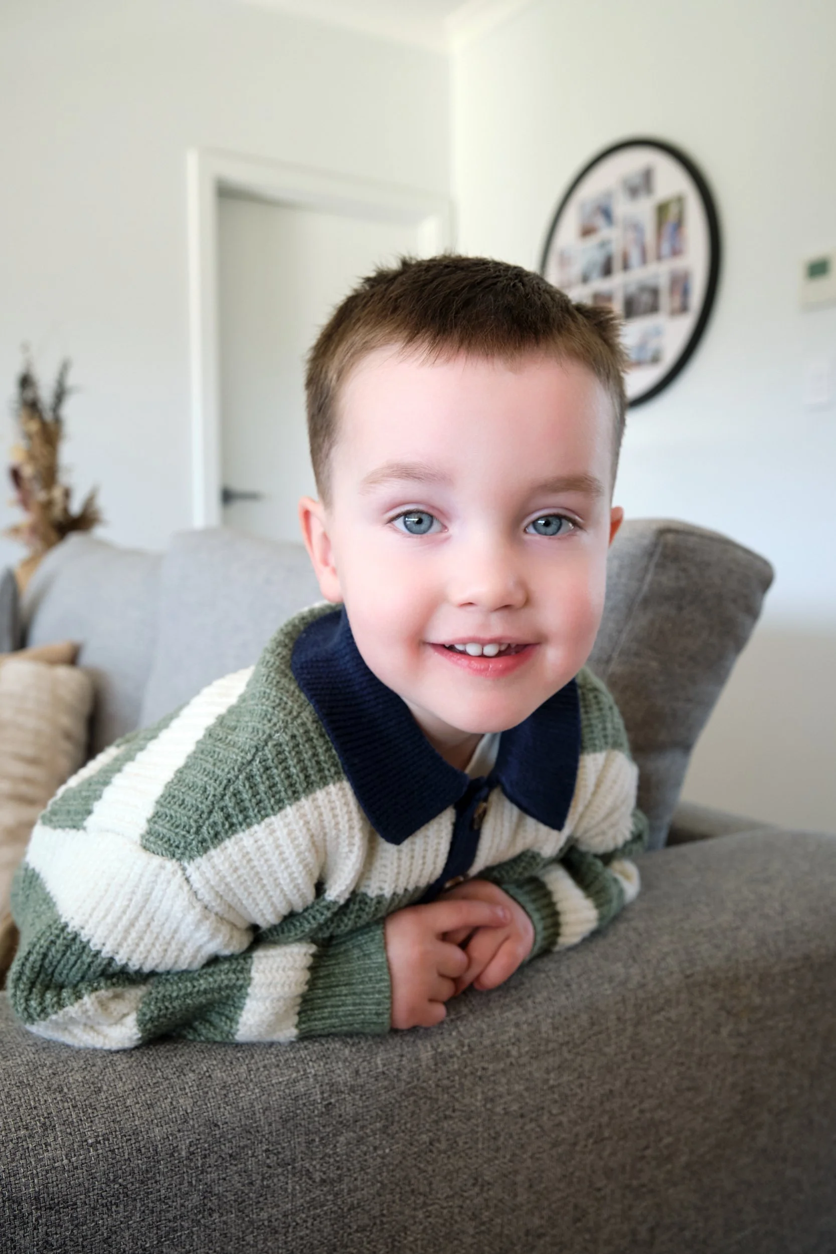hill-launceston-newborn-family-photography-young-boy-smiling-on-couch.jpeg