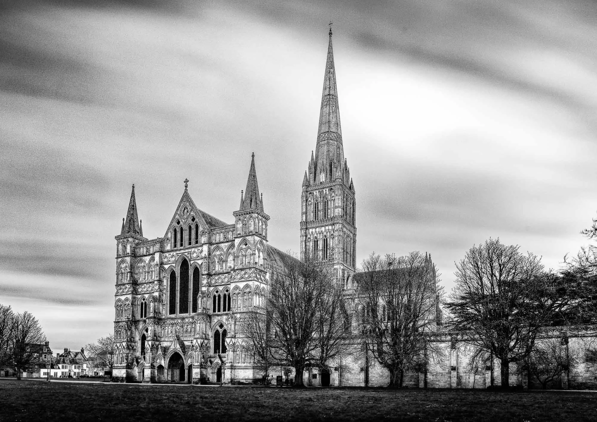 Salisbury Cathedral under drifting clouds—timeless Gothic architecture in black and white.