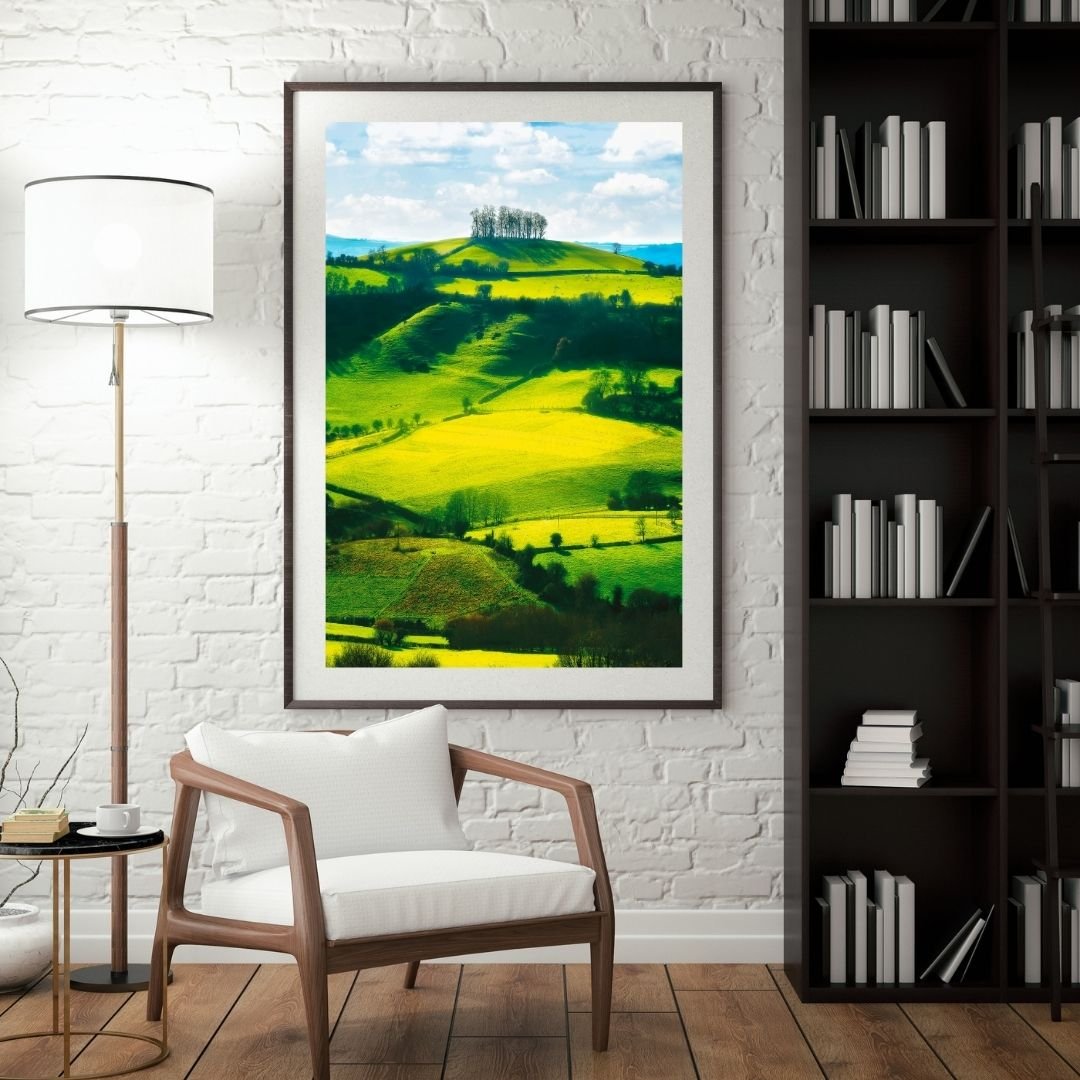 Room mock up of Golden light illuminating rolling green hills at Kelston Round Hill with a crown of trees atop the summit, English countryside landscape